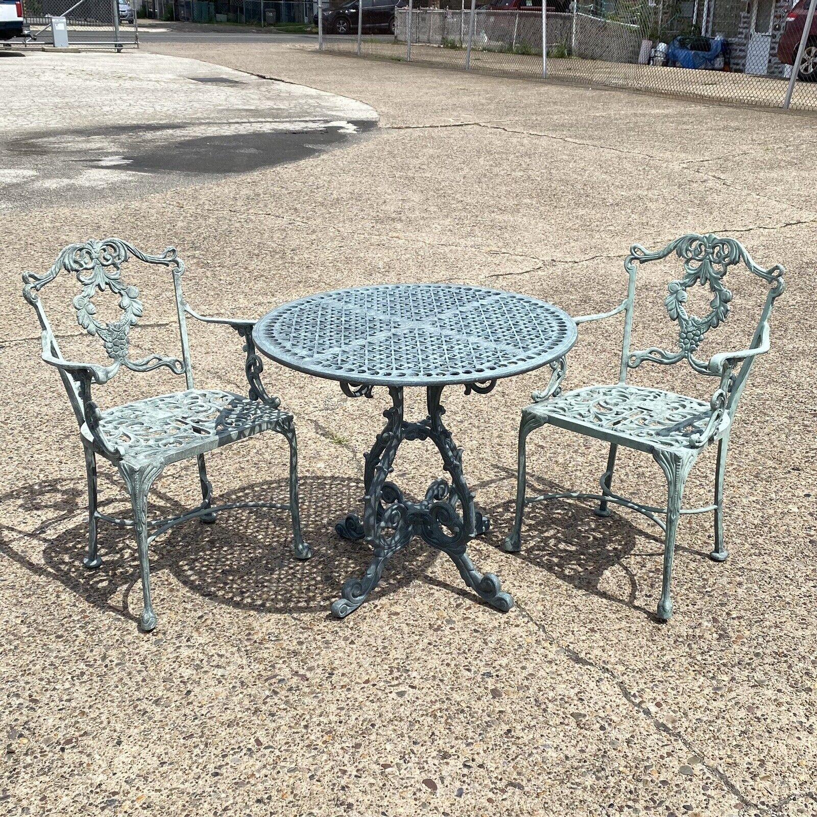 Landgrave Cast Classics Victorian Style Green Aluminum Garden Patio Bistro Dining Set - 3 Pc Set. Item features a green distressed finish, heavy cast aluminum construction, 2 chairs and one small round table. Circa Late 20th Century.
Measurements: