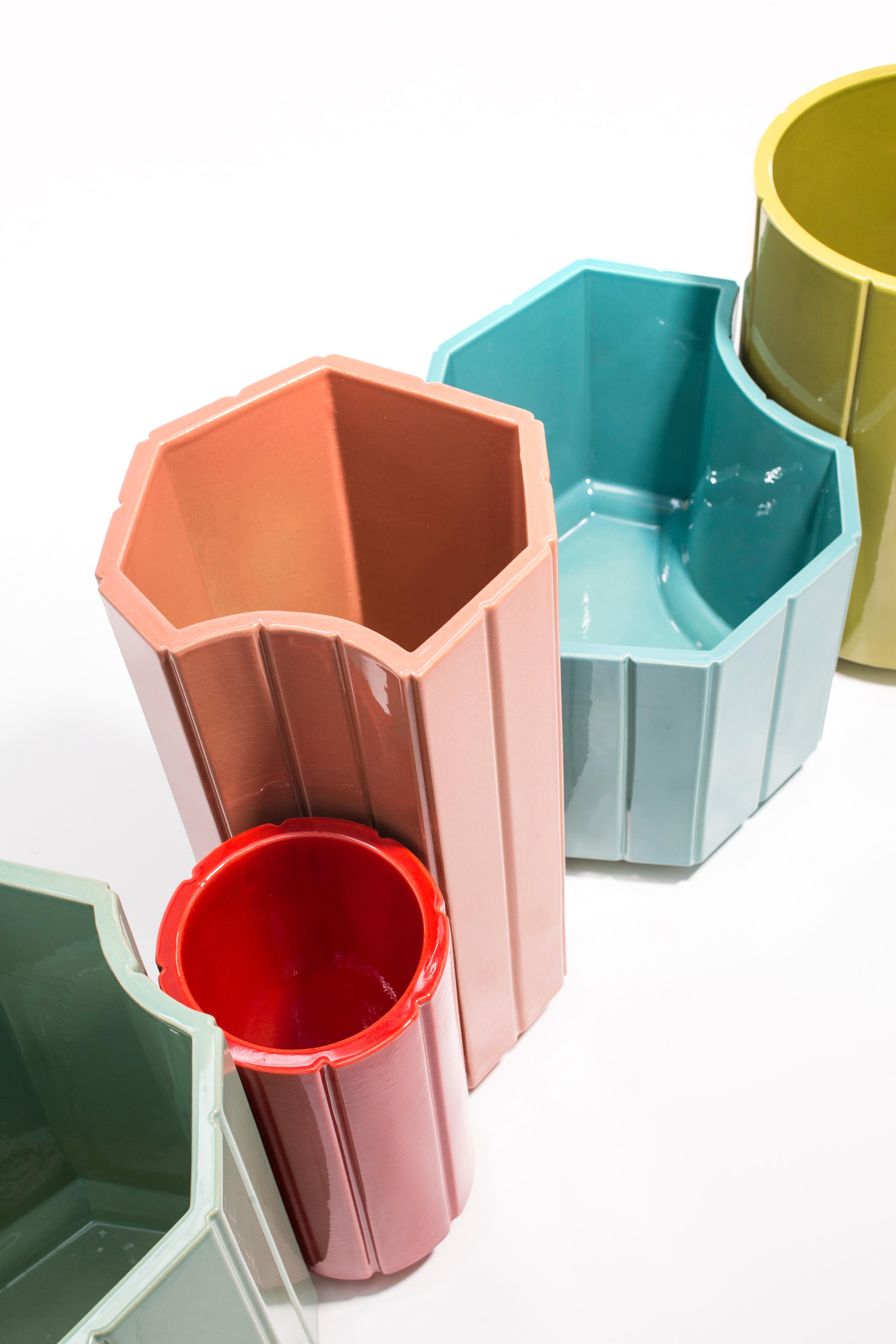 The landscapes vases are conceived in glazed ceramic with dense and vivid colours. Every element, every cell put on the ground composes the detail of an urban and graphic landscape. The scenery envisions the idea of the garden: a composition that