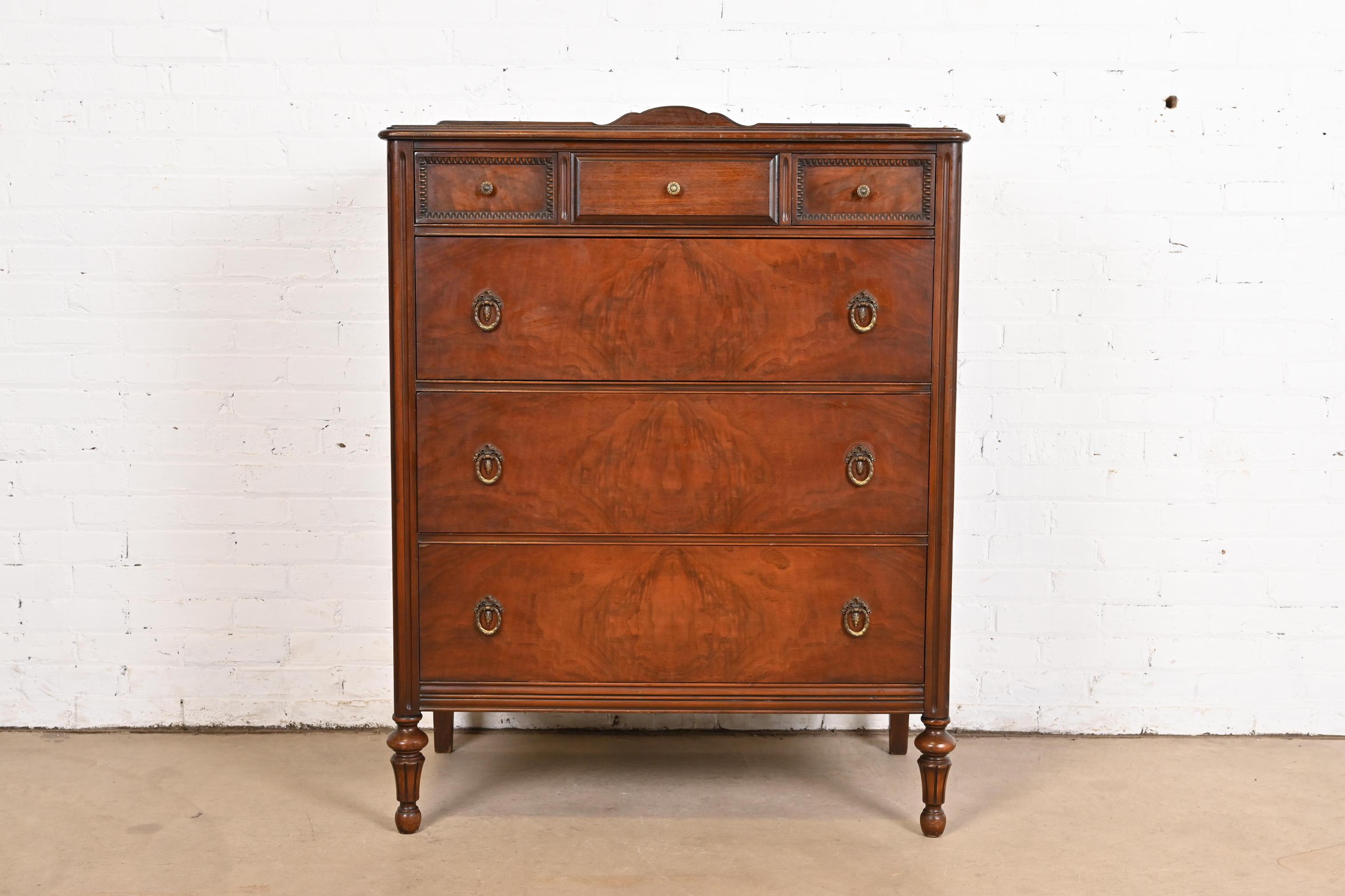 A gorgeous vintage French Regency Louis XVI style highboy dresser or chest of drawers

By Landstrom Furniture

USA, Circa 1940s

Beautiful book-matched burled walnut, with original brass hardware.

Measures: 37
