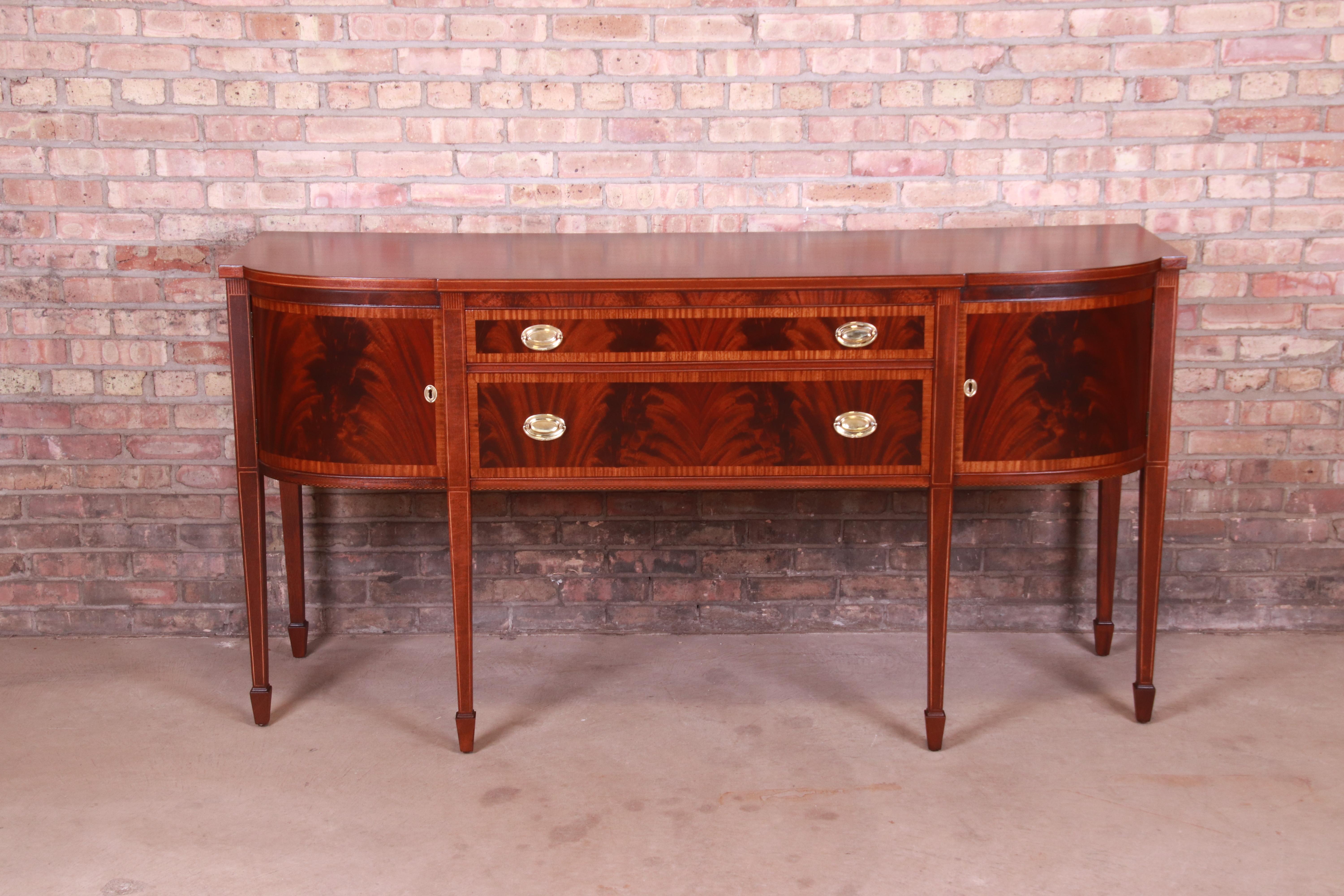 An exceptional Georgian or Hepplewhite style sideboard or credenza

By Landstrom Furniture

USA, Circa 1940s

Book-matched flame mahogany, with satinwood banding and string inlay, and original brass hardware.

Measures: 72