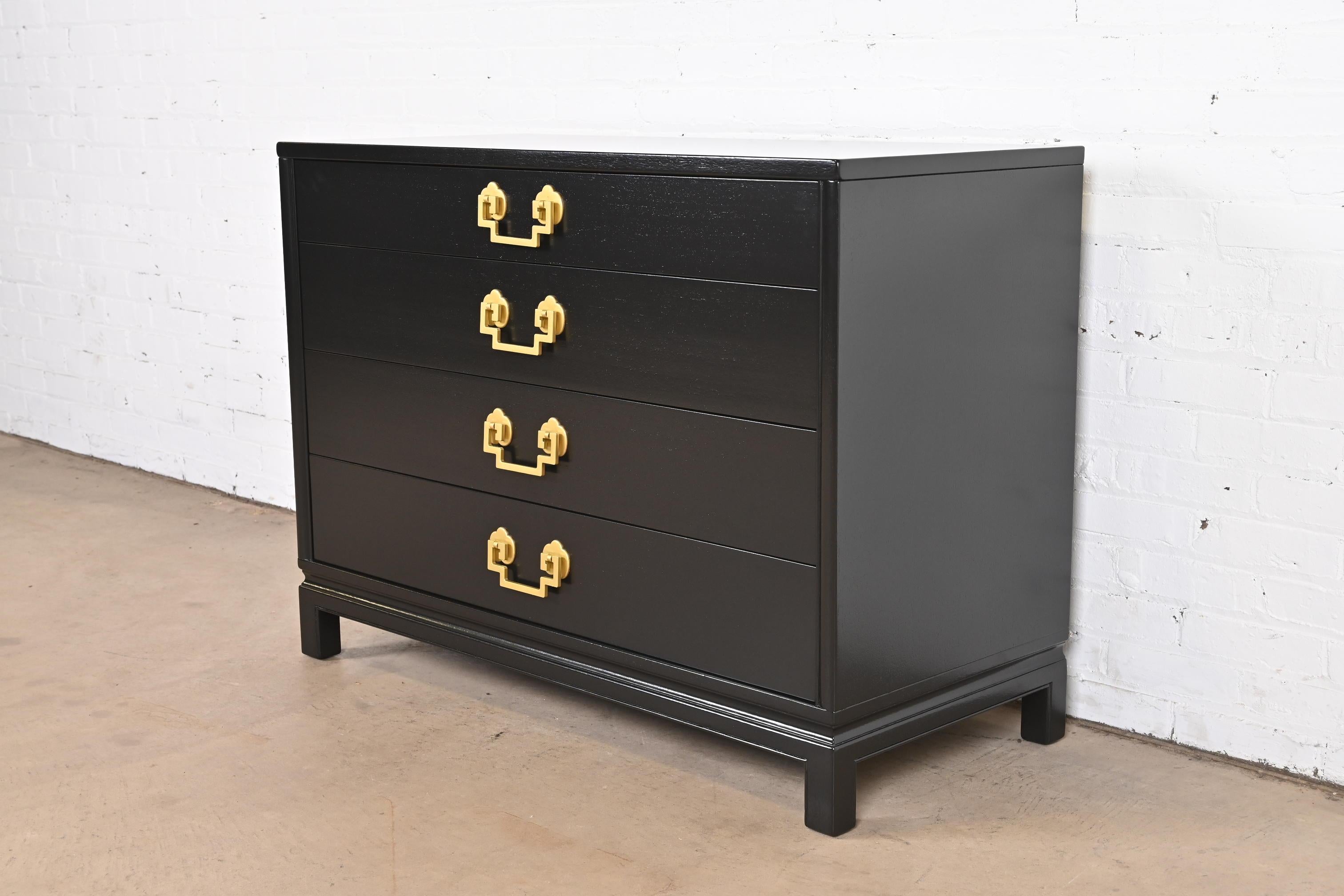An exceptional Mid-Century Modern Hollywood Regency Chinoiserie four-drawer dresser chest or commode

By Landstrom Furniture

USA, 1952

Black lacquered mahogany, with Asian-inspired brass hardware.

Measures: 44