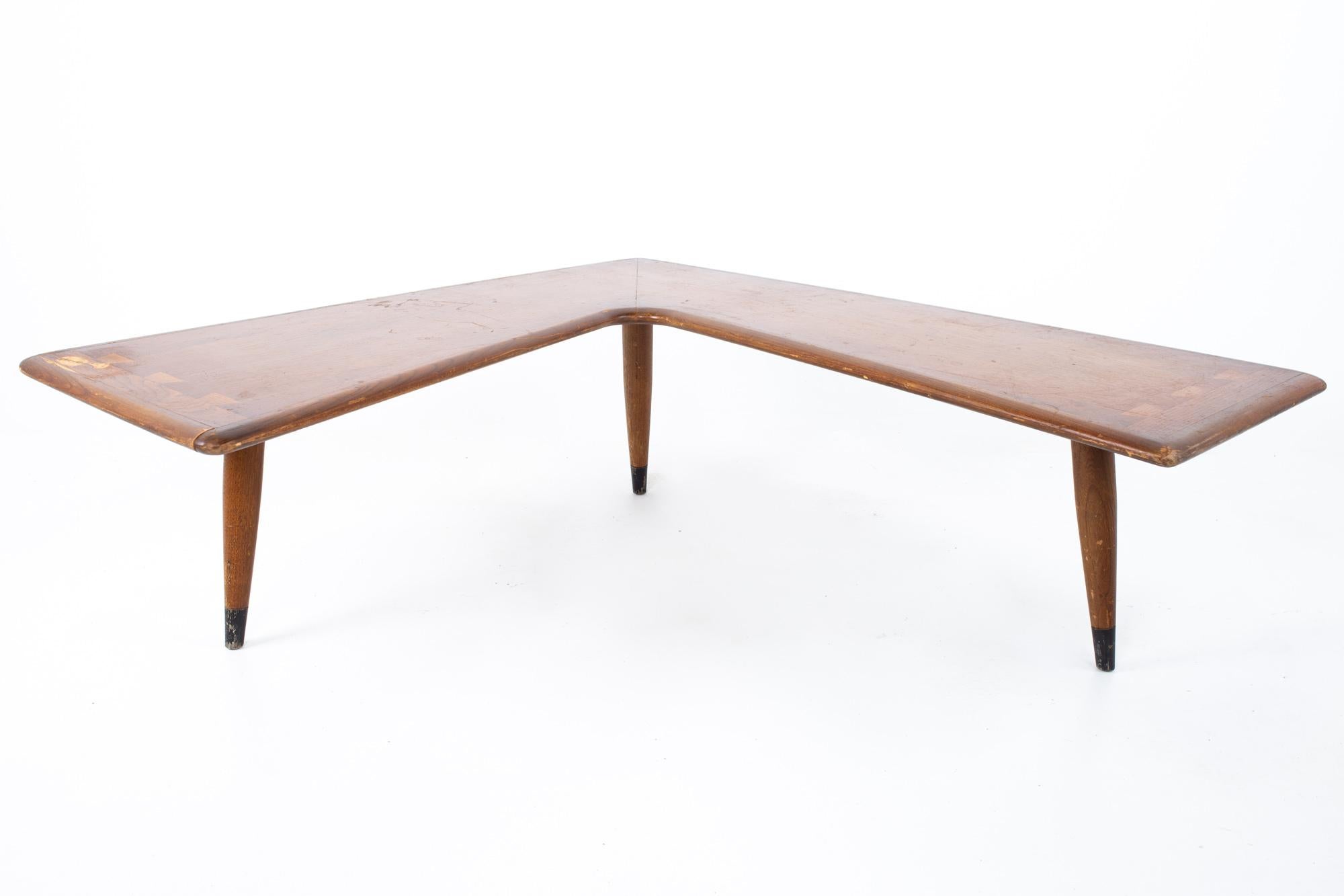 Lane Acclaim mid century walnut dovetail boomerang coffee table

Measures: 63.5 inches corner to corner, 44/48 width (depending on which side is measured), 20/17.5 deep (depending on which side is measured), 14.5 high

All pieces of furniture