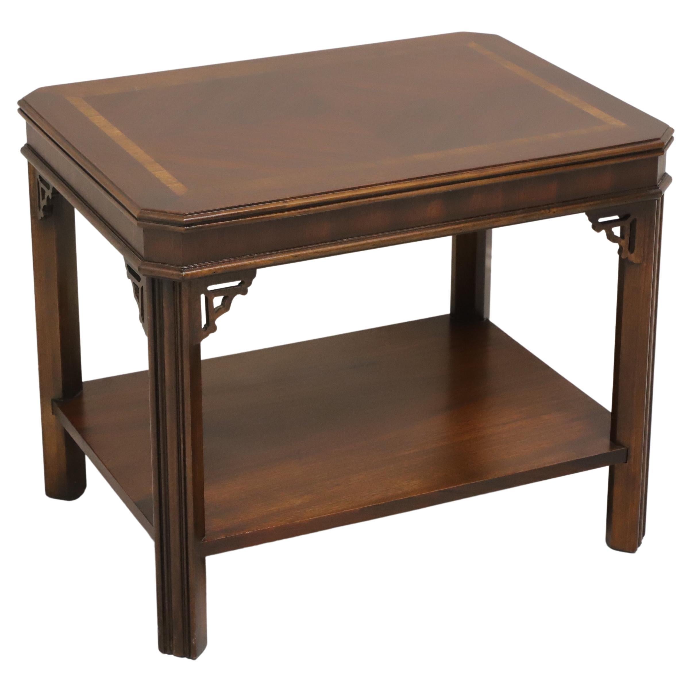 A Chippendale style side table by Lane Furniture. Mahogany with inlaid & banded top, bevel edge apron, fretwork accents to corner joints, a lower tier shelf, and fluted straight legs. Made in Altavista, Virginia, USA, in the late 20th century.