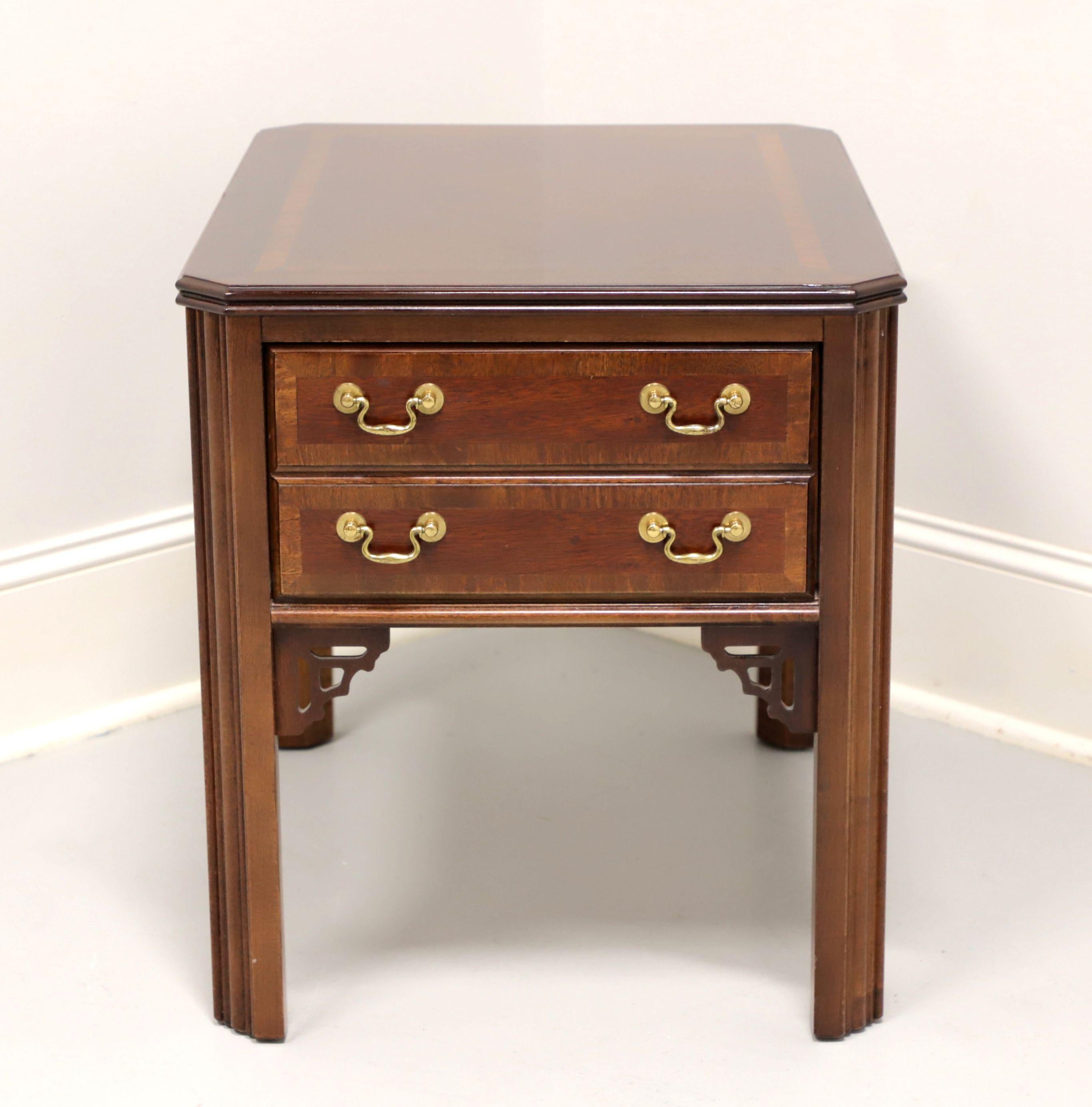 A Chippendale style side table by Lane Furniture. Mahogany with inlaid & banded top, brass hardware, banded drawer fronts, fretwork accents to corner joints, and fluted straight legs. Features one drawer of dovetail construction. Made in Altavista,