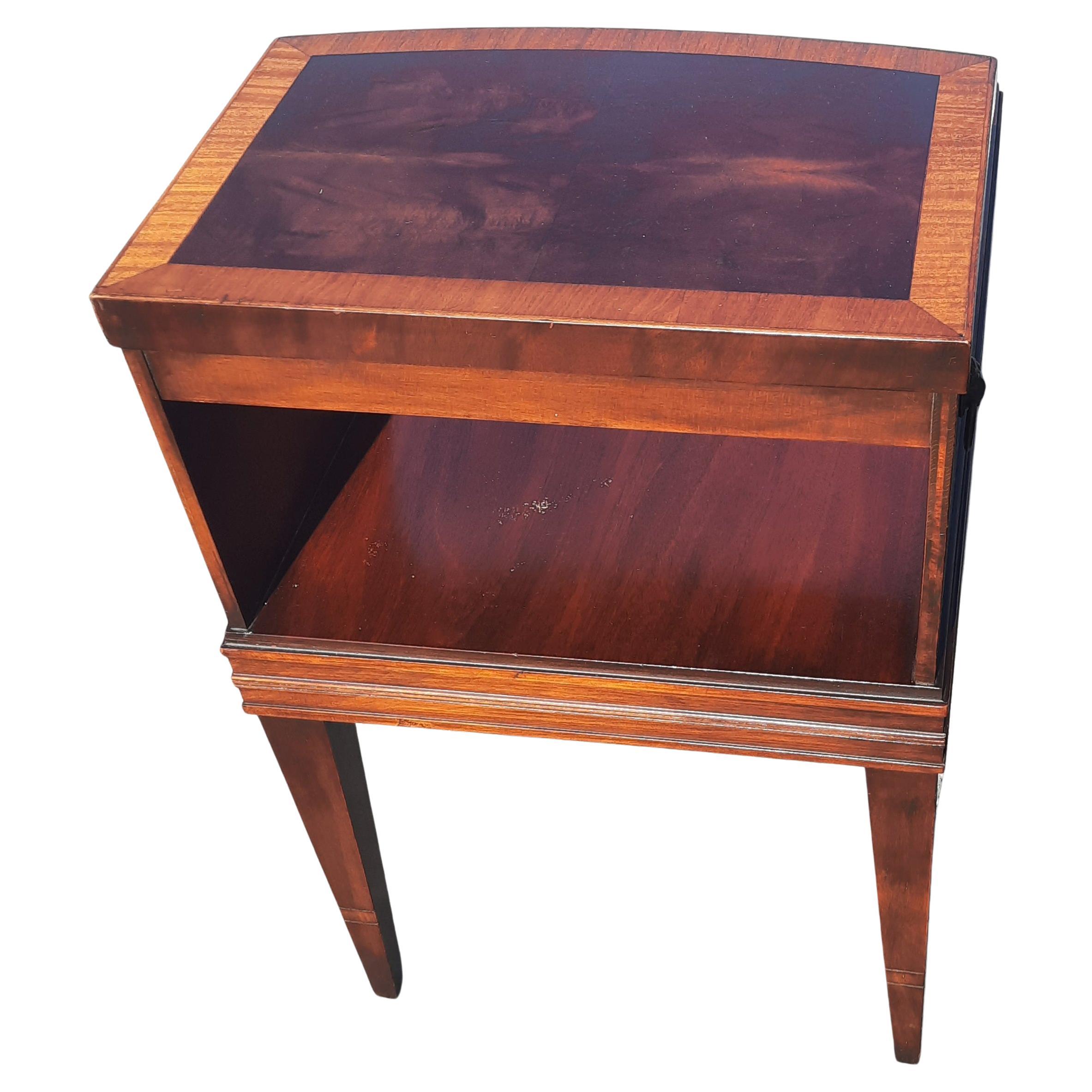 Pair of Lane Acclaim attributed Antique two-tier step up flame mahogany and satinwood banded top side tables. Very good vintage condition. Wear appropriate with age and use. Circa 1930s. See pictures. one of the tables has a 1/3 dimmed ring barely