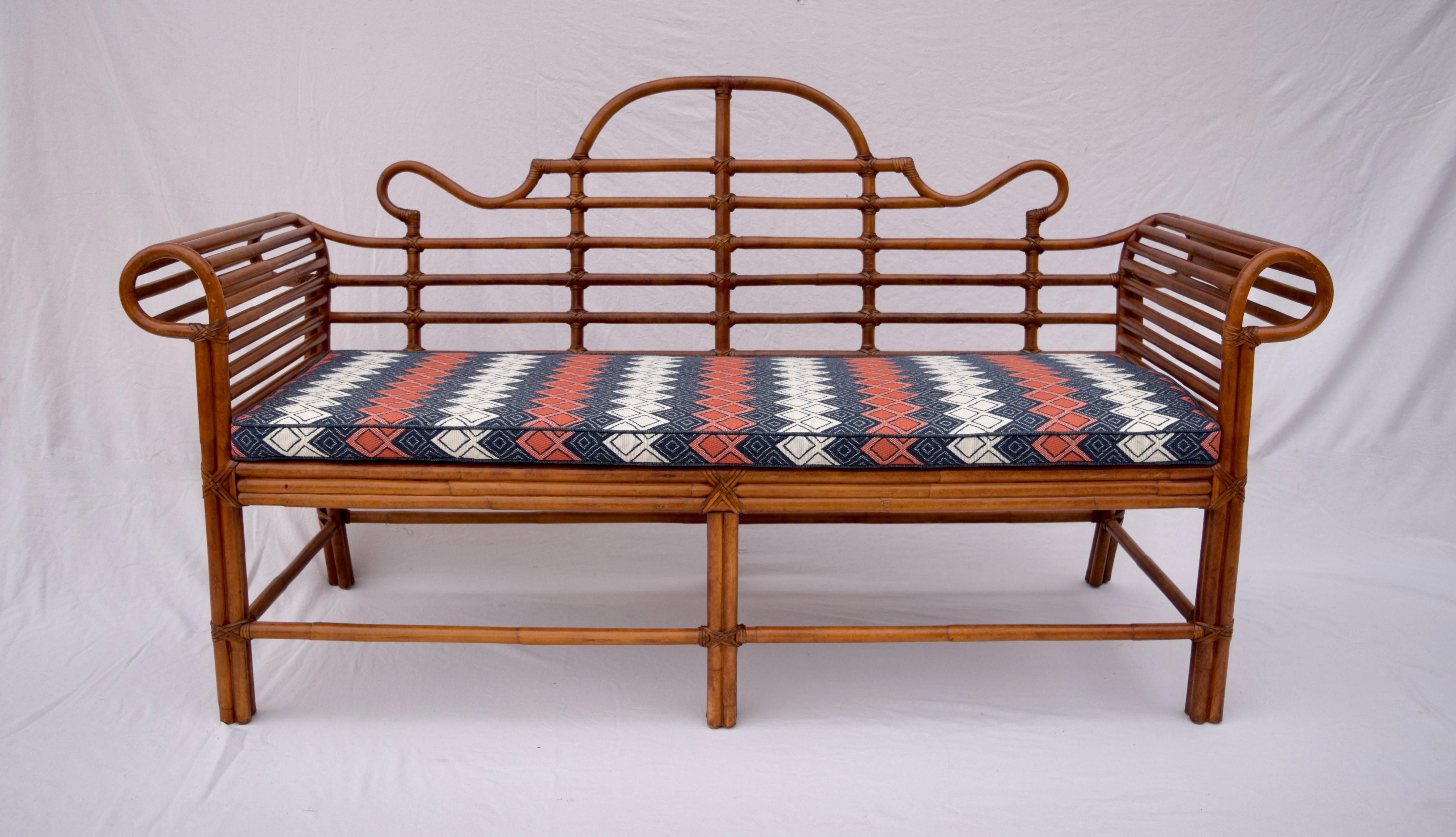 Bent bamboo scroll arm chinoiserie sofa by Lane. Leather joinery throughout and substantial caned seat enhanced with new cushions rich in Indigo, persimmon and antique white tones in marvelous needlepoint textured woven upholstery. Unusual limited