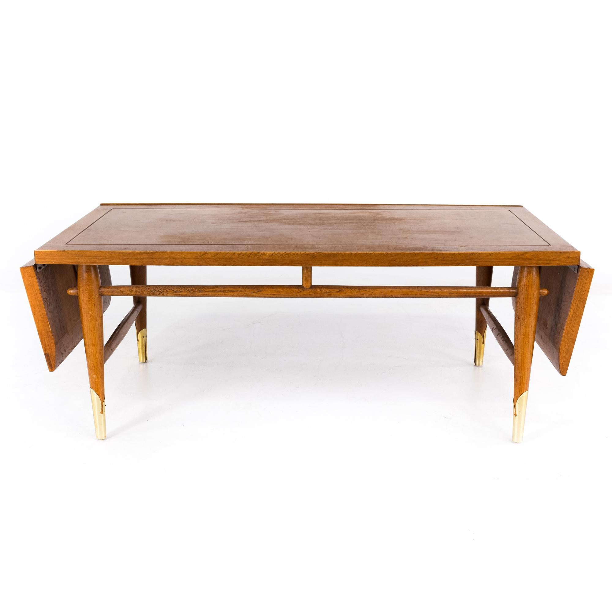 Lane Copenhagen mid century walnut and brass drop leaf coffee table

This table measures: 60 wide x 23 deep x 17 inches high

All pieces of furniture can be had in what we call restored vintage condition. That means the piece is restored upon