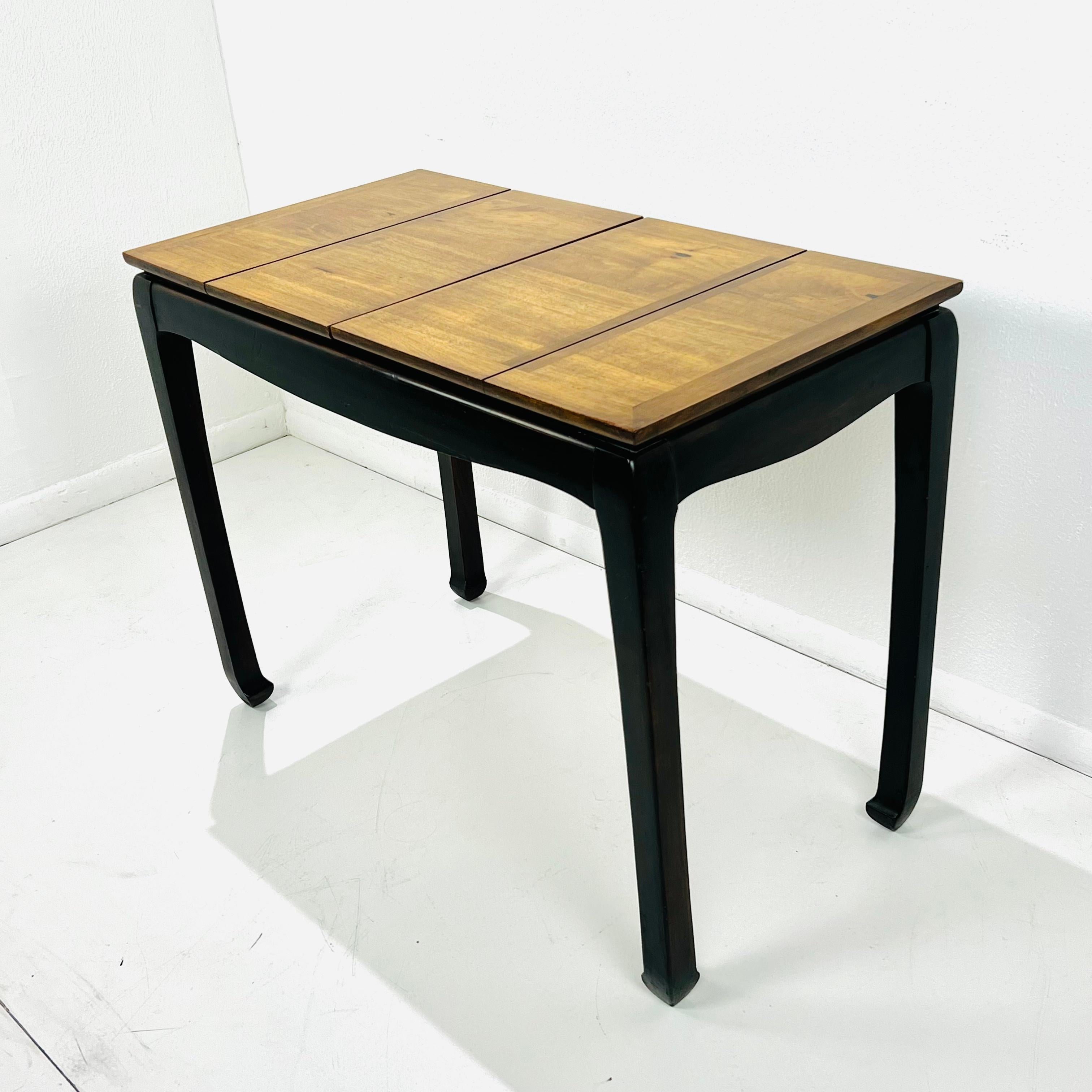 The two different types of wood finishes make a nice contrast on this fantastic Ming style convertible game table by Lane Furniture. The bottom portion and legs are in the classic Chinoiserie style in an ebonized wood finish and the table top is a