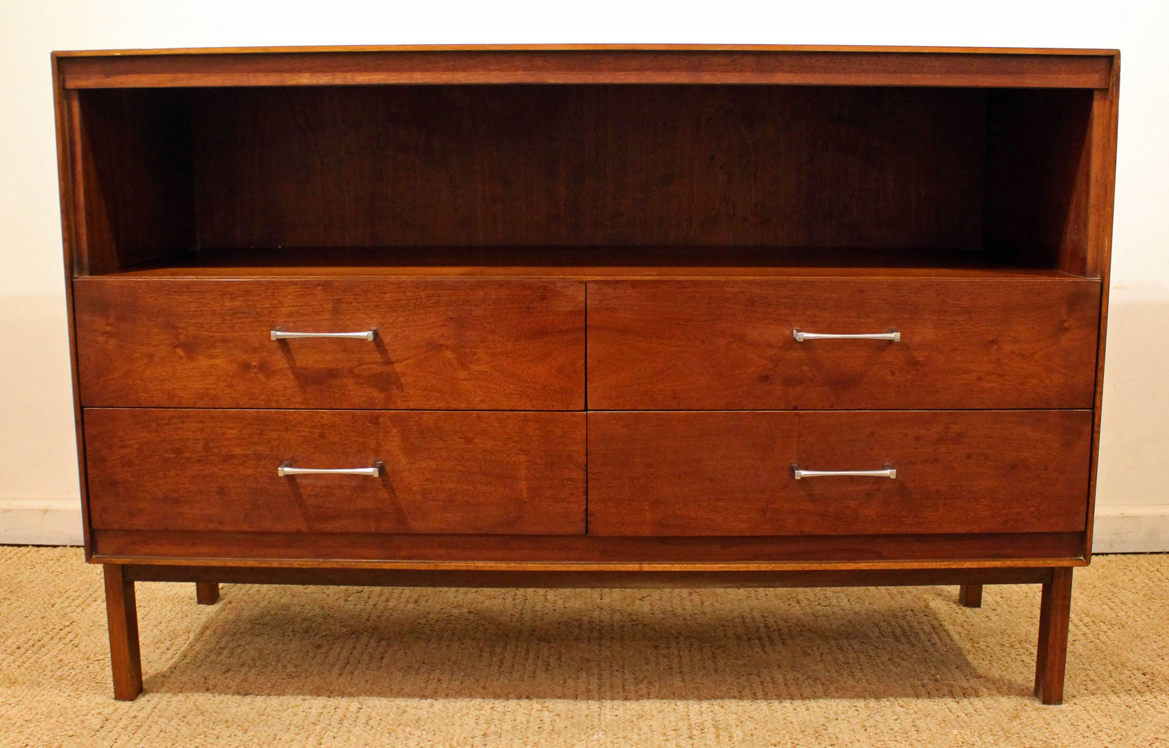 This piece looks to be walnut with dovetailed edges and chrome pulls. It is signed by Lane.

Dimensions:
48