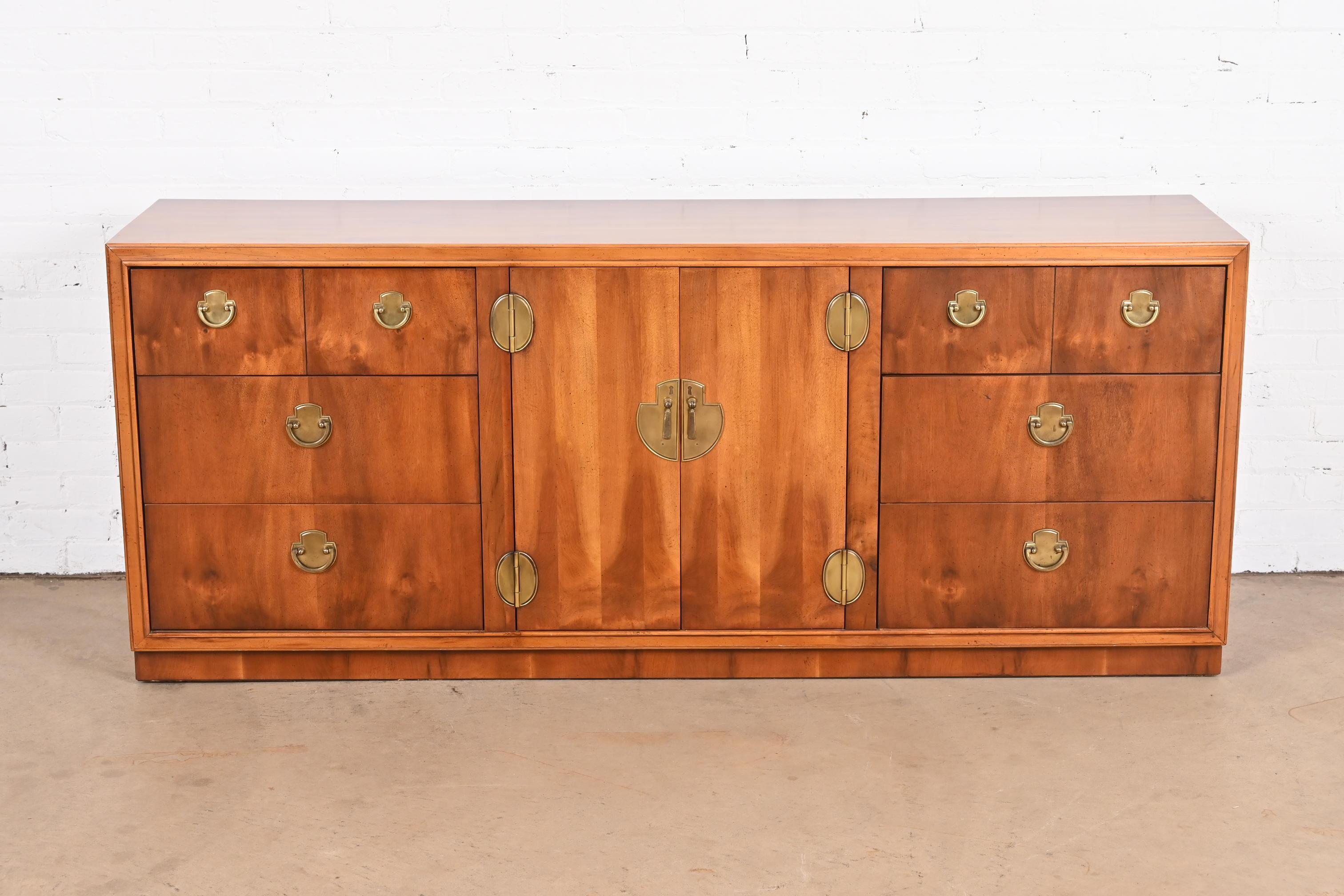 An exceptional mid-century modern Hollywood Regency Campaign style dresser or credenza

By Lane Furniture

USA, Circa 1970s

Gorgeous yew wood, with original brass hardware.

Measures: 72