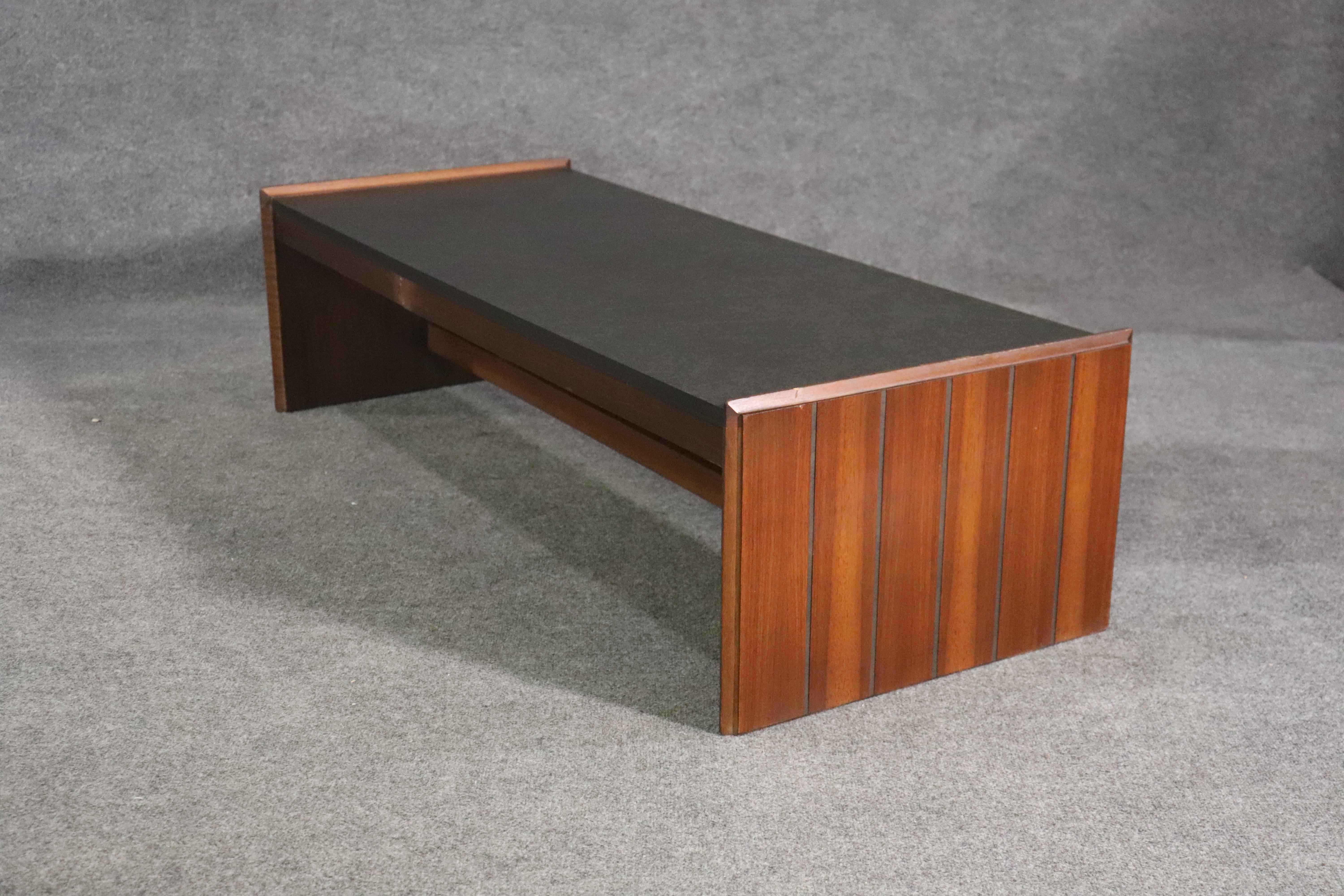 Mid-century modern coffee table with faux stone top and walnut wood frame. 
Please confirm location NY or NJ