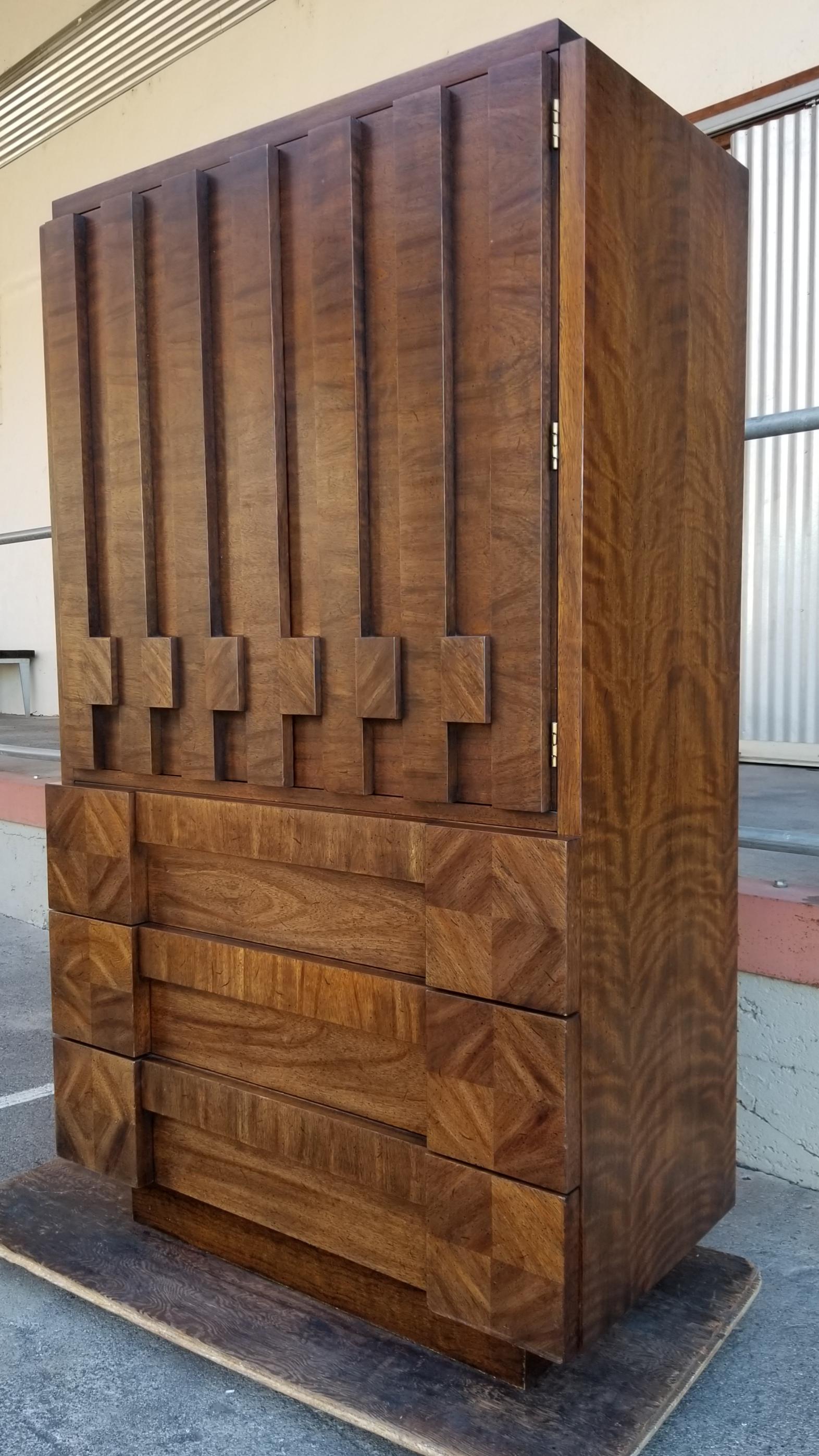 Striking Brutalist design and ample storage in this 1970s Lane Furniture cabinet. Lane's Staccato line, very similar to the Mosaic line. Booked matched wood grain cubist detail. Features 3 large drawers and 2 cabinet doors opening to a 4th drawer