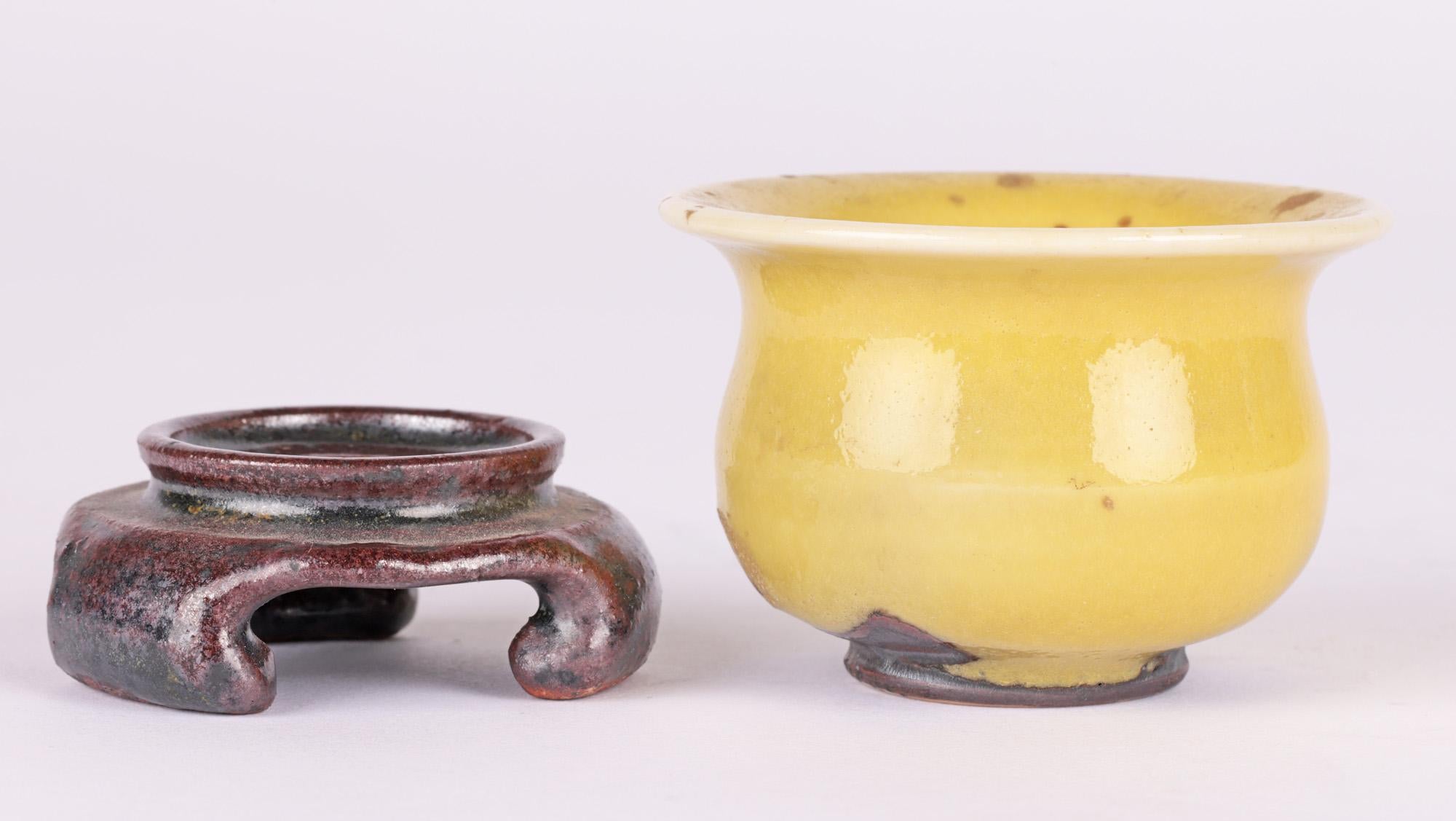 A stunning Canadian studio pottery miniature bowl decorated in yellow glazes with an associated pottery stand by Lane Gordon Thorlaksson (Canadian, 1937-2009) dated 1976. 

Lane Gordon Thorlaksson was born in 1937 in Winnipeg, Manitoba and moved