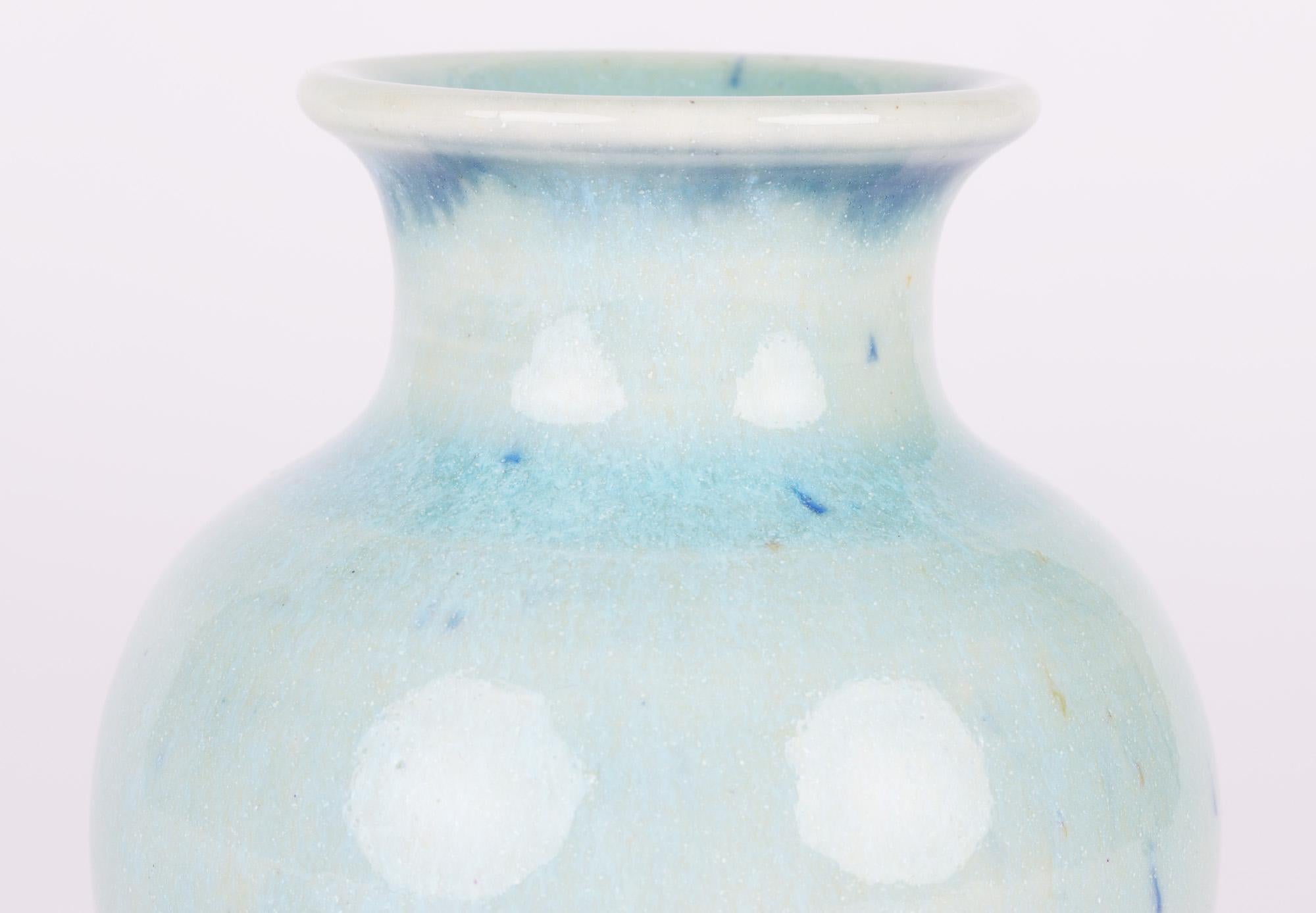 A stunning Canadian studio pottery vase decorated in light blue glazes with an associated pottery stand by Lane Gordon Thorlaksson (Canadian, 1937-2009) dated 1972. 

Lane Gordon Thorlaksson was born in 1937 in Winnipeg, Manitoba and moved to