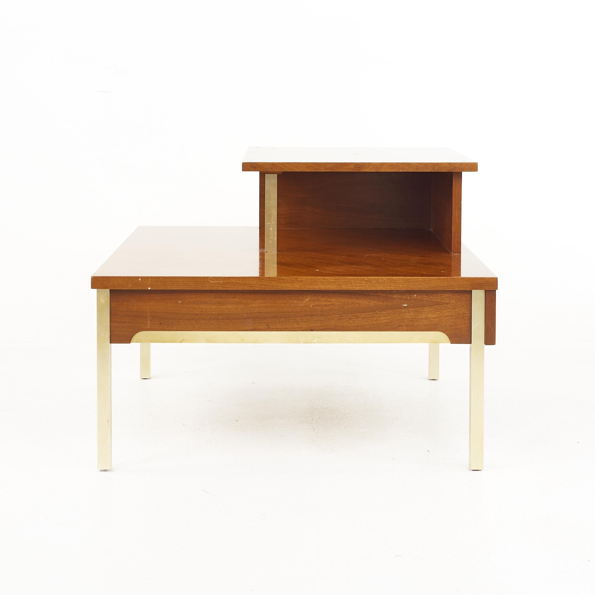 Lane mid century 2 tier brass accent and walnut corner table 

The table measures: 31.25 wide x 31.25 deep x 23.25 inches high

All pieces of furniture can be had in what we call restored vintage condition. That means the piece is restored upon