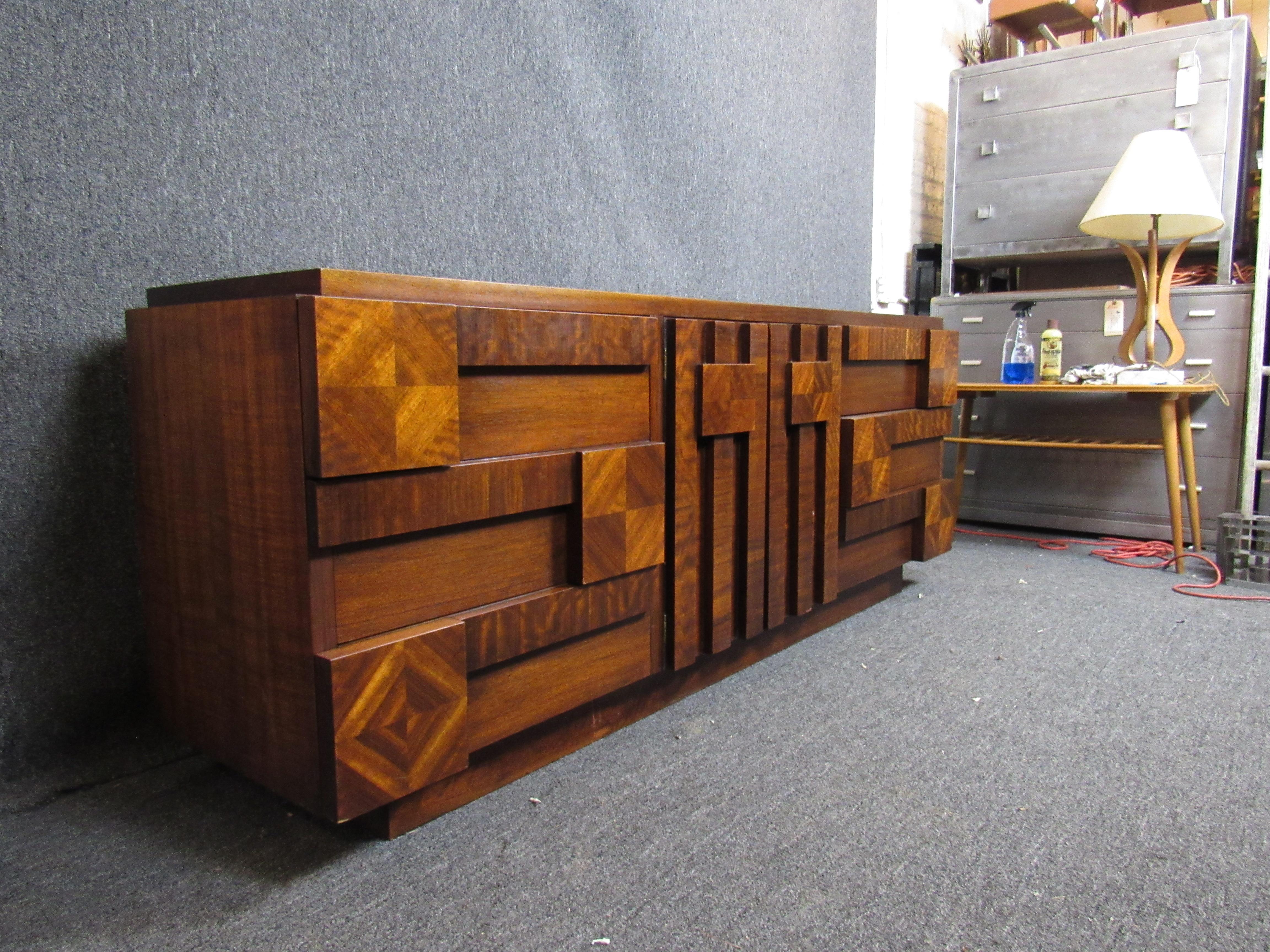 Stunning mid-century brutalist dresser made by the world-renowned Lane Furniture Company from Altavista, Virginia. Nine large drawers for plenty of organization and storage. The bold, carved front is sure to make a statement in any room. 

(Please