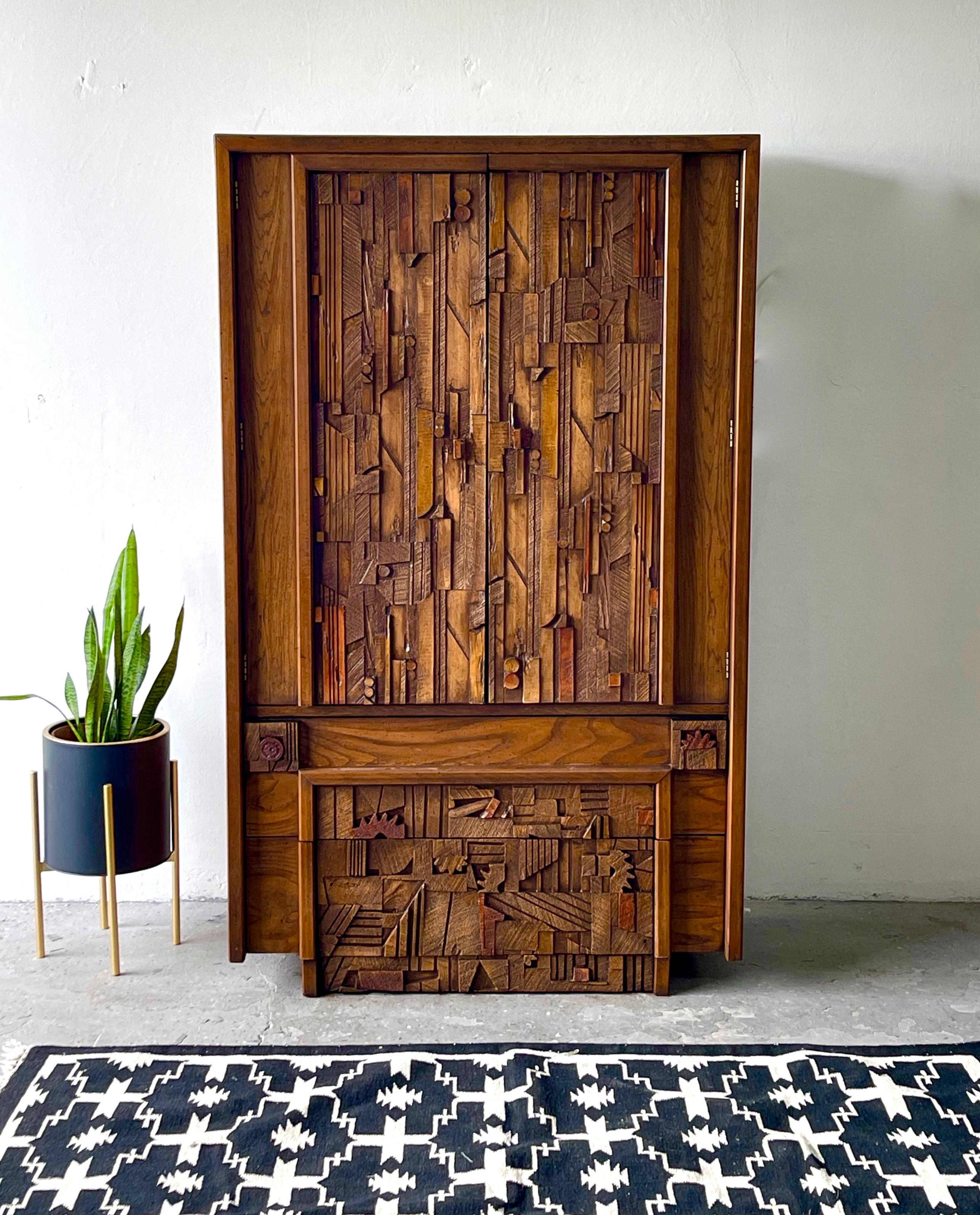 A Mid-Century Modern Brutalist tall armoire dresser by Lane “Pueblo” in the style of Paul Evans. Lots of storage with four drawers and adjustable shelving. Original finish 

Original finish 

Measures: 39.75” wide. 18” deep. 66” tall.