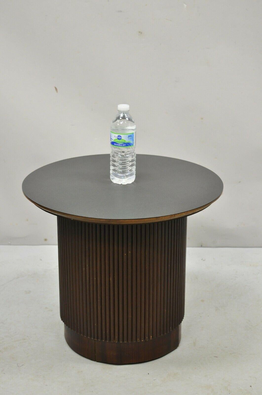Lane Mid-Century Modern walnut round black laminate top drum side table. Item features black laminate top, wooden ribbed base, clean Modernist lines, great style and form. Circa 1960s. Measurements: 17