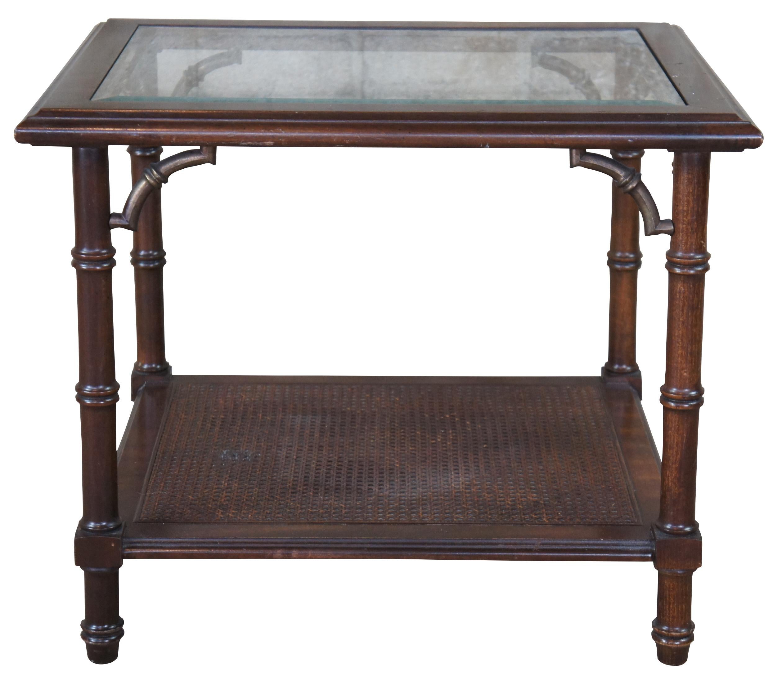 Vintage lane Altavista two tier side, end or accent table. Made of walnut featuring faux bamboo styling with beveled glass inset top and caned wicker lower tier. Modern Chinoiserie. 1366-05.
 