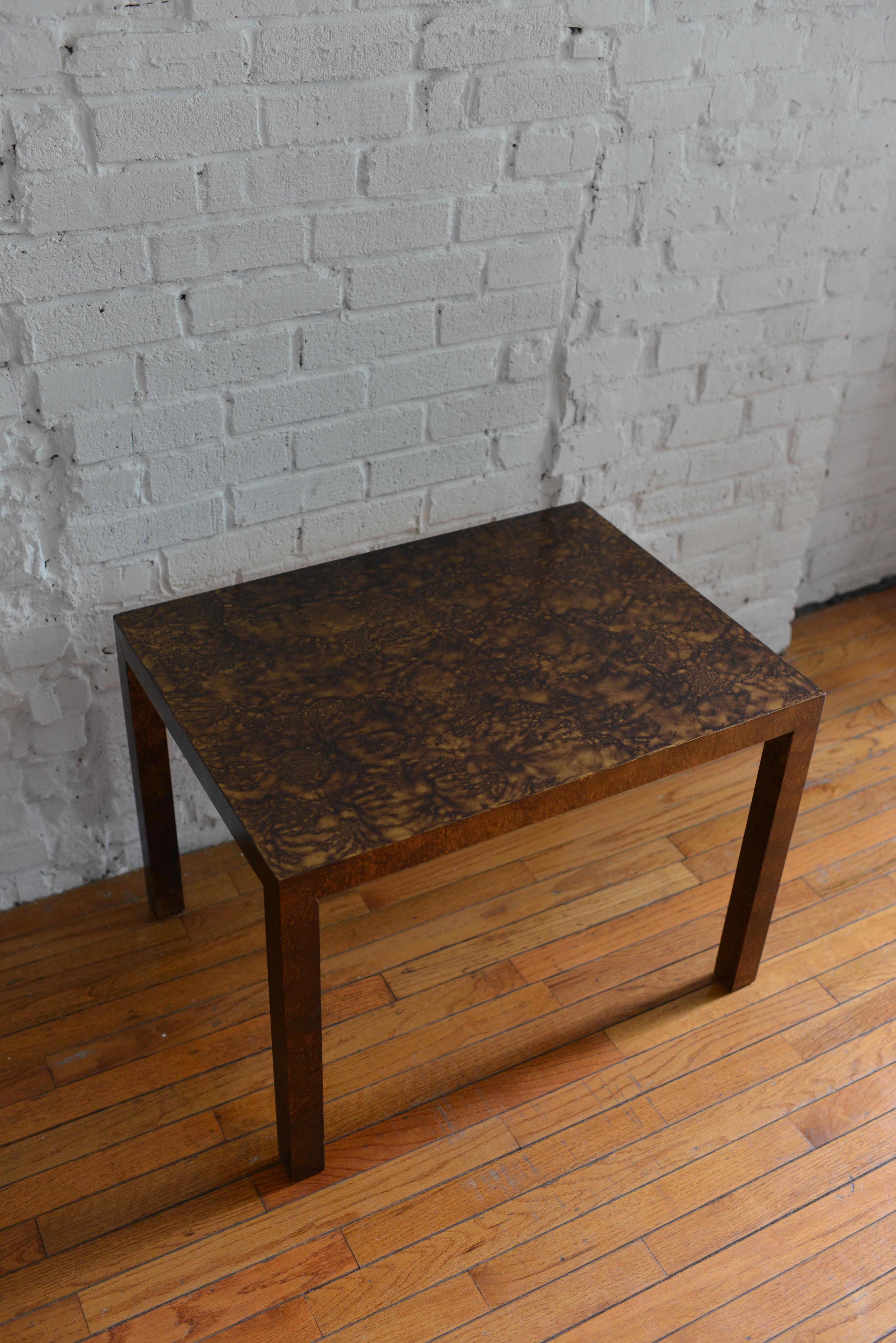 This Milo Baughman-inspired parsons table was produced in the mid-20th century for Lane Furniture. It features gorgeous deep, faux burlwood on wood laminate. Marked on bottom with 