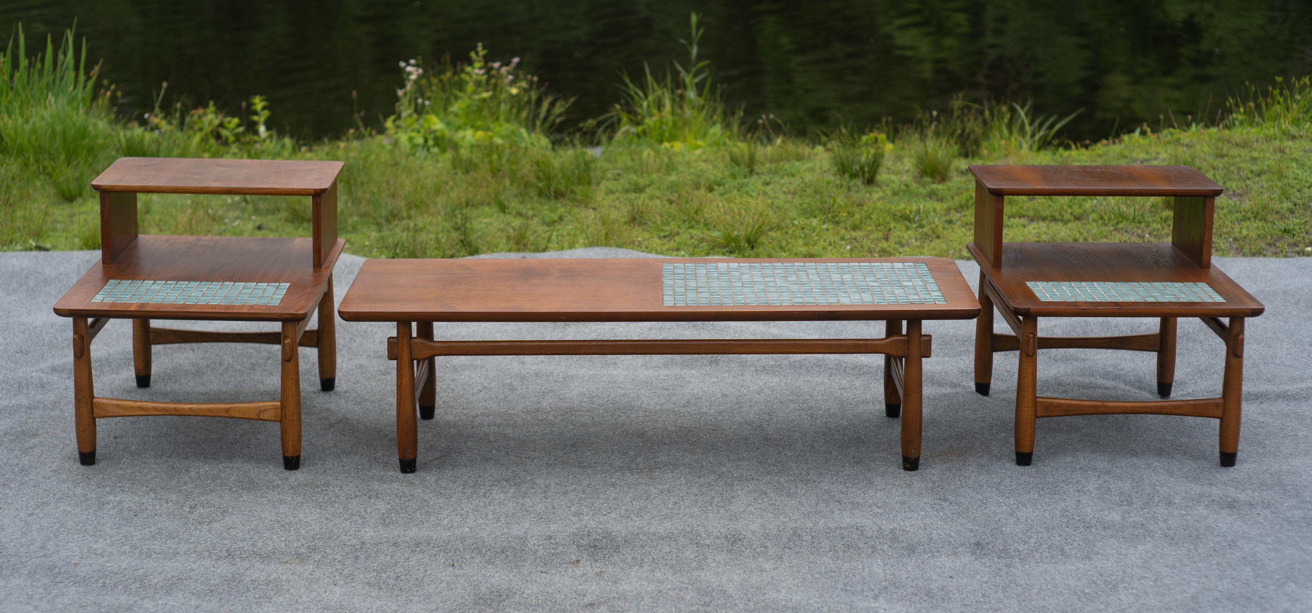 Designed and made in the United States in the 1960s, this set of tables features high-quality walnut construction and inlays of square blue cermic tiles. The grain is nicely figured, and the cermaic is saturated and bright depite its age. Each leg