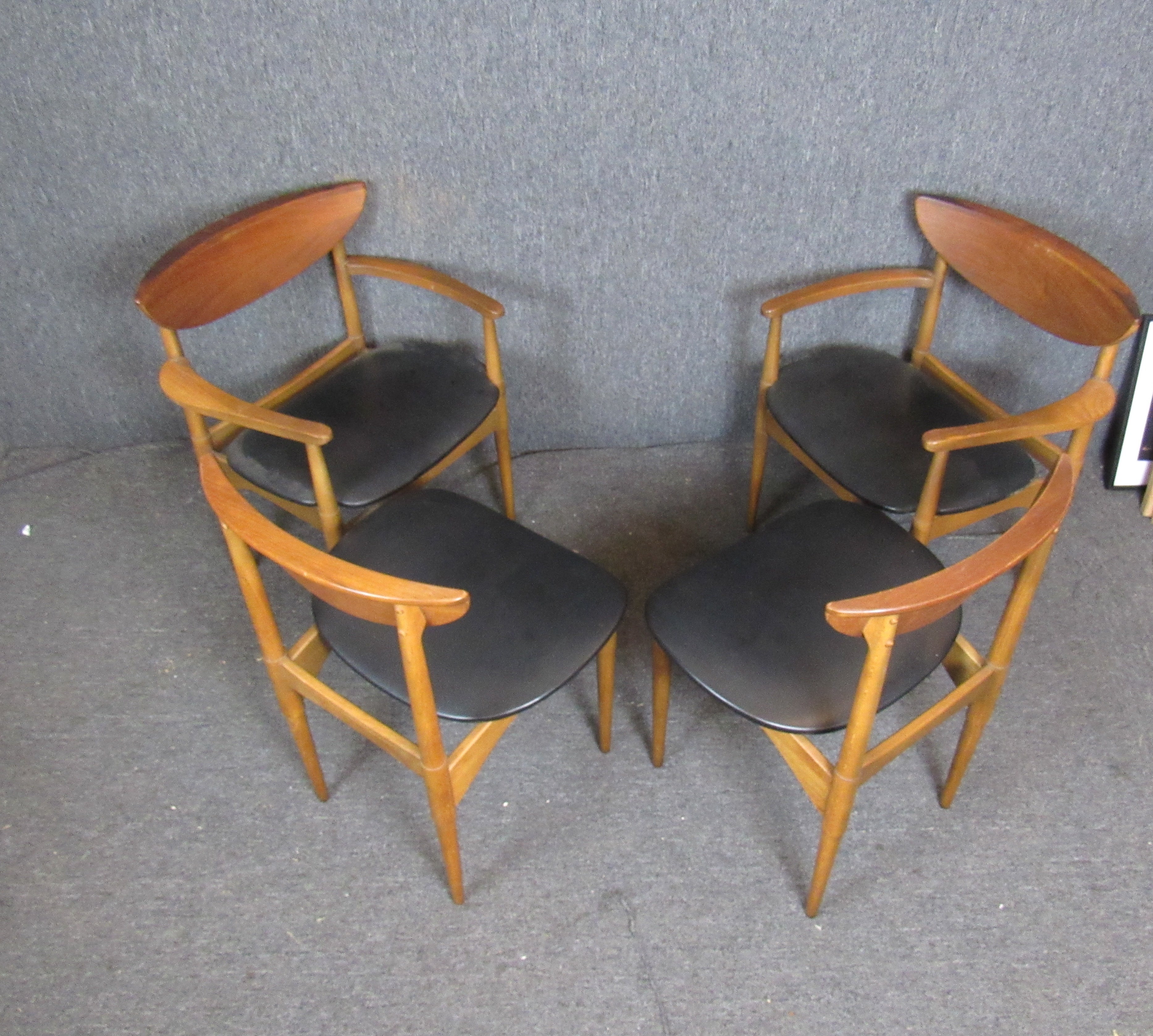 Set of four dining chairs designed for Lane Furniture by Warren Church. Unique seat backs with a fold over design. Set includes two arm chairs and two side chairs. Arm chairs measure 24