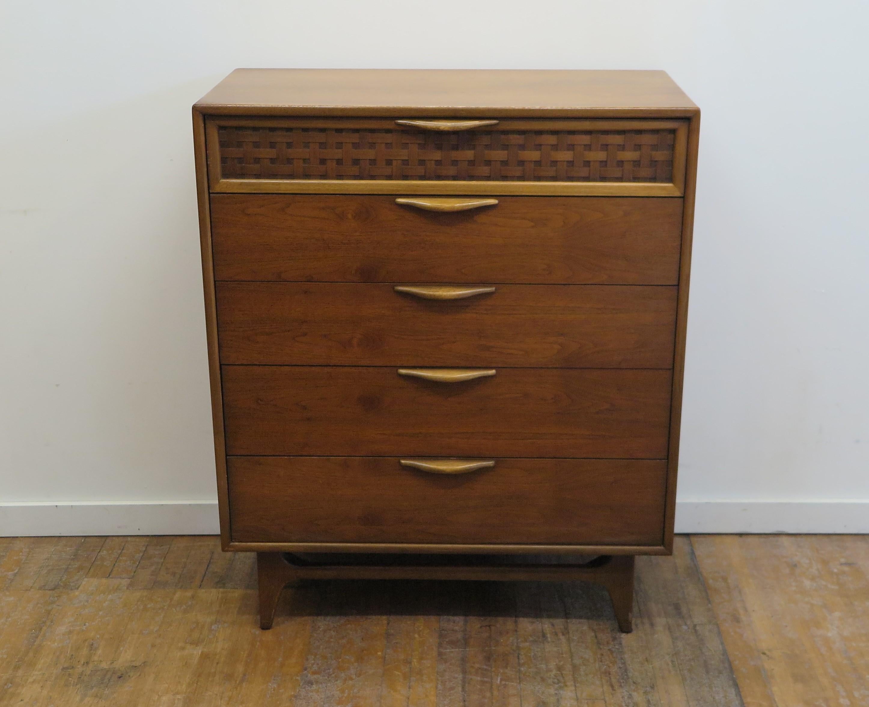 Lane mid-century modern perception highboy dresser designed by Warren Church. Five drawer highboy dresser having sculpted handles, woven walnut detail to top drawer. Waterfall edged top adds a subtle elegance to this piece. Clean inside and out,