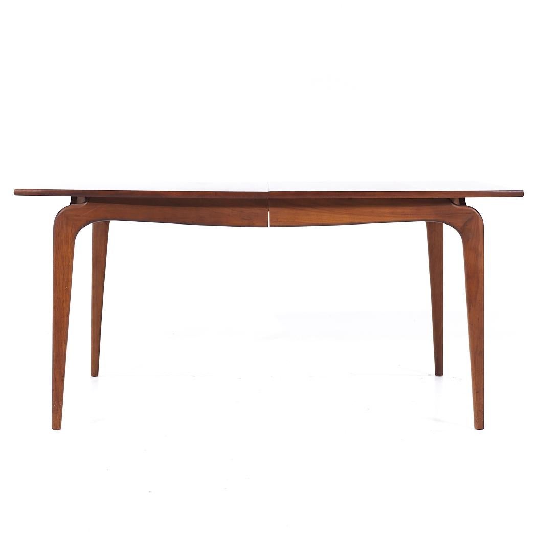 Lane Perception Mid Century Walnut Expanding Dining Table with 3 Leaves

This table measures: 62 wide x 42 deep x 29.25 inches high, with a chair clearance of 24.75 inches, each leaf measures 12 inches wide, making a maximum table width of 98 inches