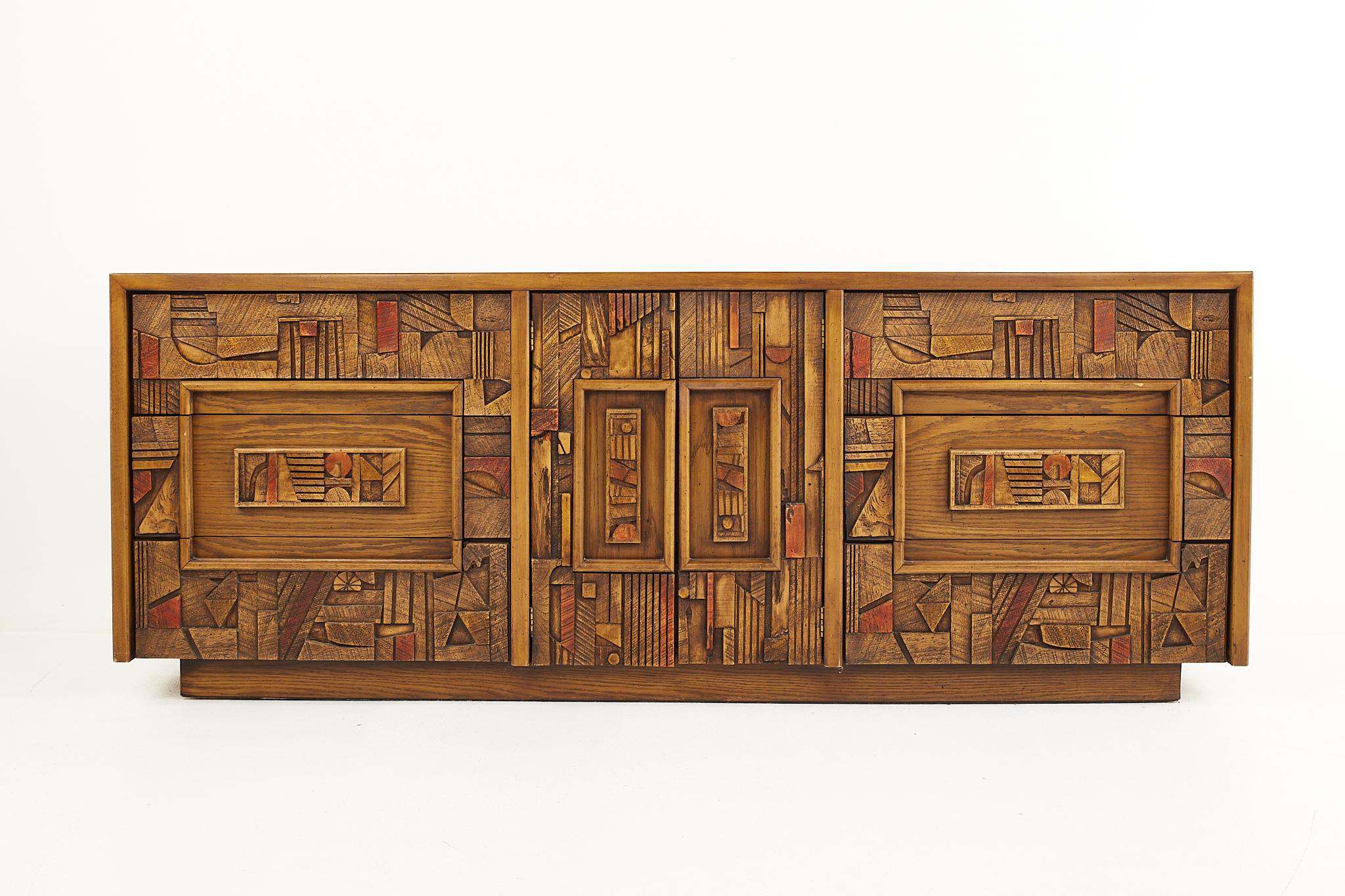 Lane Pueblo Brutalist mid-century 9 drawer lowboy dresser

The dresser measures: 78 wide x 18 deep x 30 inches high

All pieces of furniture can be had in what we call restored vintage condition. That means the piece is restored upon purchase so