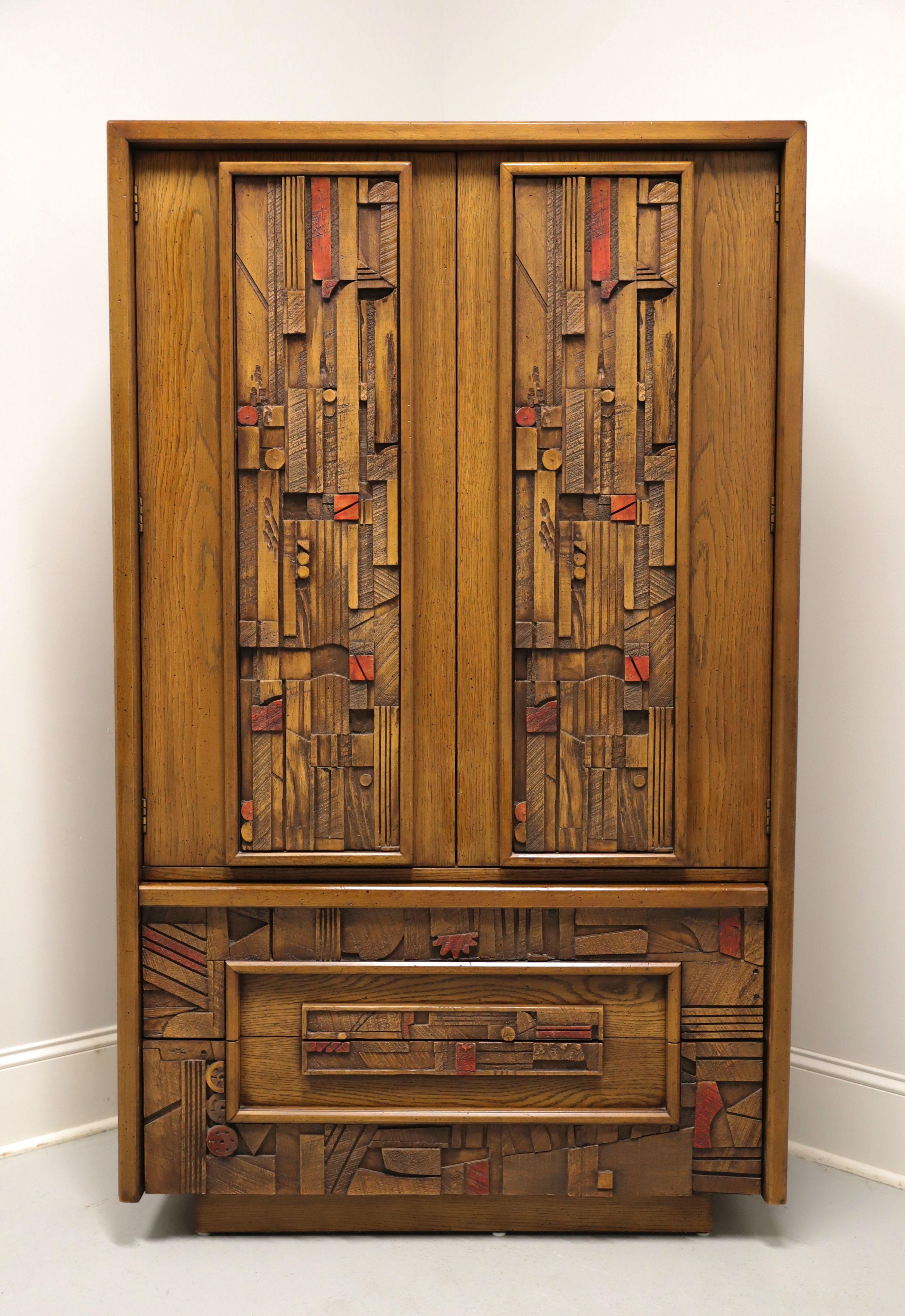 A Mid 20th Century Brutalist style gentleman's chest by Lane Furniture, from their Pueblo Collection. Oak with slightly distressed finish, raised intricately laid, highly textured, colorful geometric design to center of oak panel door & drawer