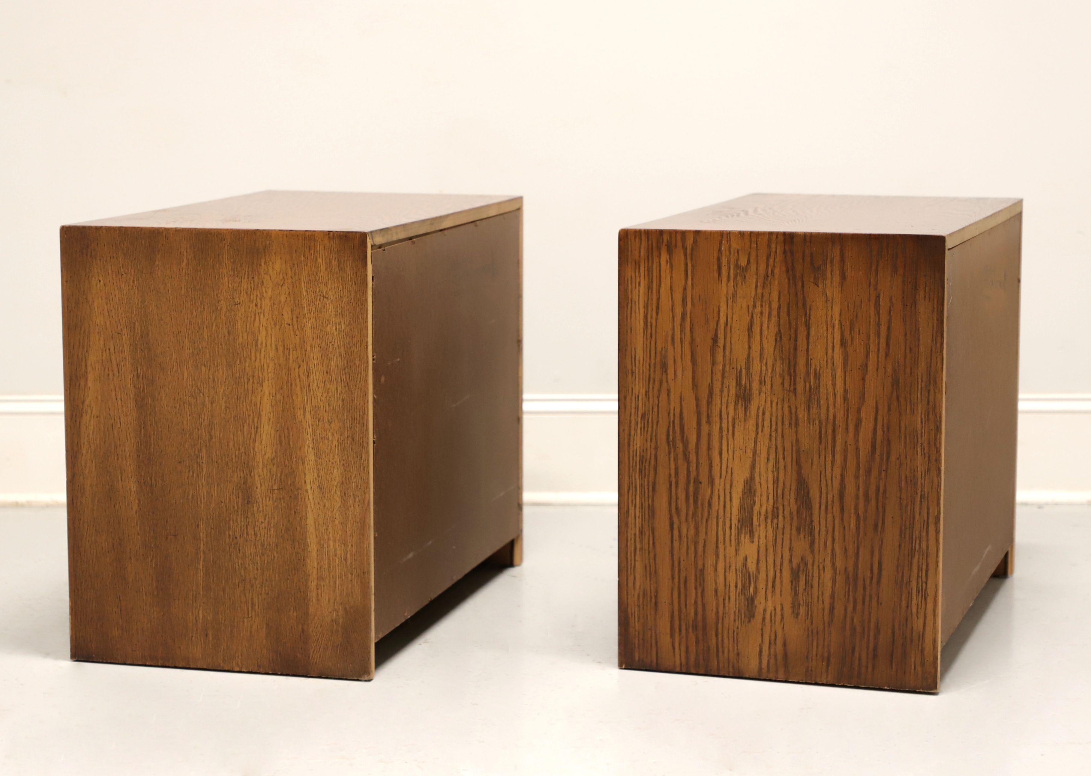 A pair of Mid 20th Century Brutalist style Nightstands by Lane Furniture, from their Pueblo Collection. Oak with slightly distressed finish, intricately laid, highly textured, colorful geometric design to door fronts, inset oak panels to center of