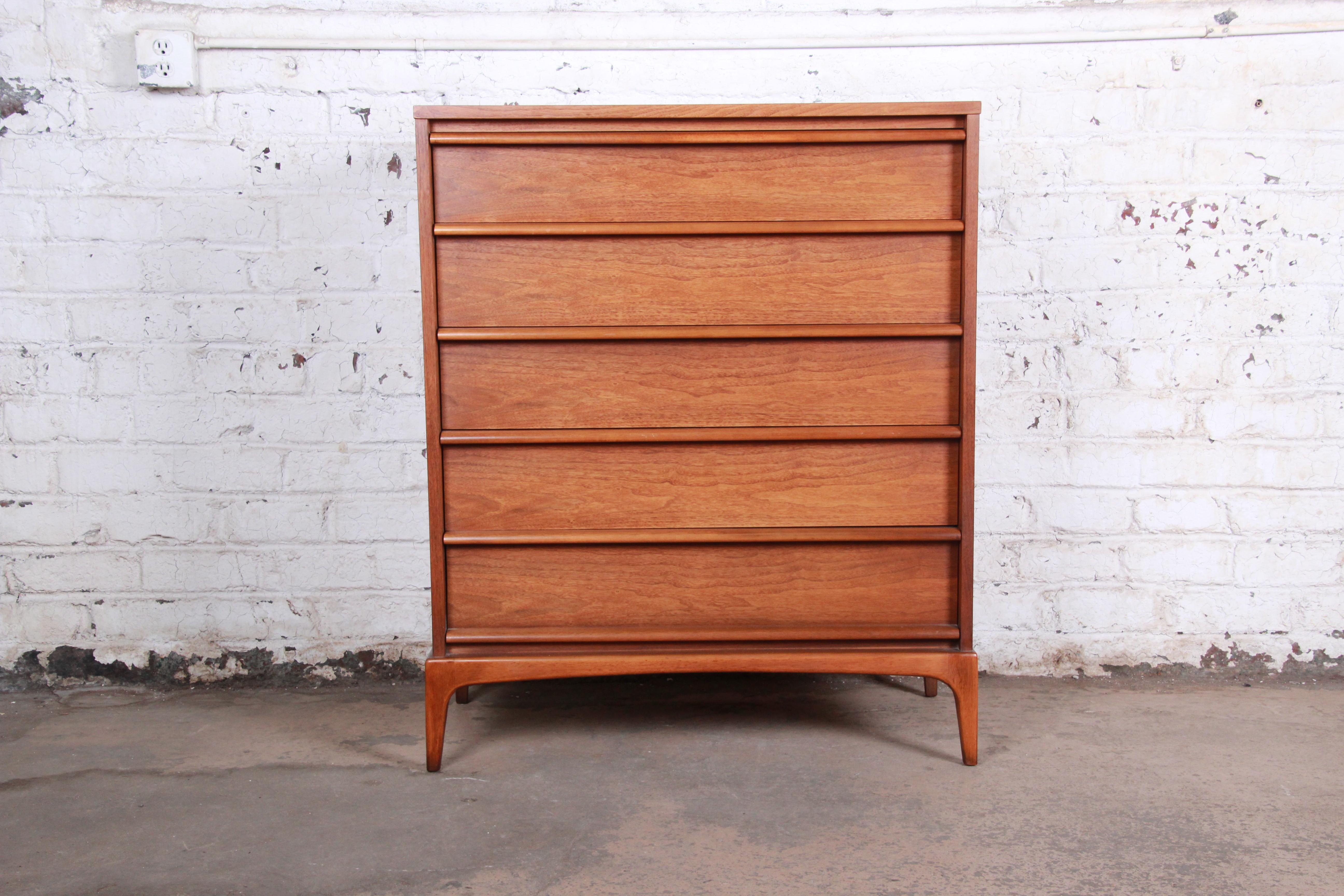 A gorgeous Mid-Century Modern walnut highboy dresser from the 
