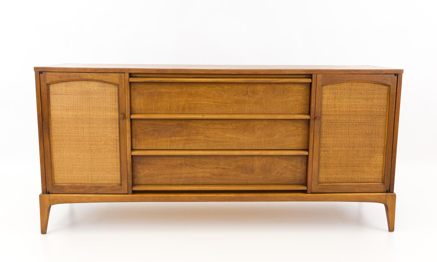 Lane rhythm mid century reversible cane door credenza.
This credenza is 66 wide x 18 deep x 31.25 inches high

All pieces of furniture can be had in what we call restored vintage condition. That means the piece is restored upon purchase so it’s