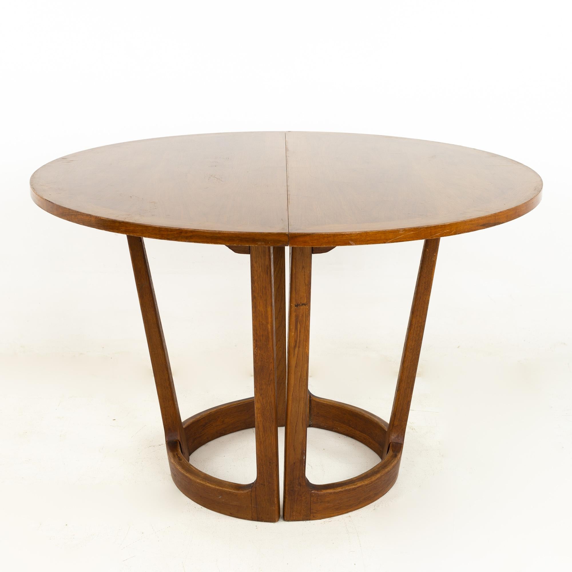 Lane Rhythm mid century round dining table

This table measures: 44 wide x 44 deep x 29 inches high, with a chair clearance of 28 inches; each leaf is 18 inches wide, making a maximum table width of 80 inches when both leaves are used

?All