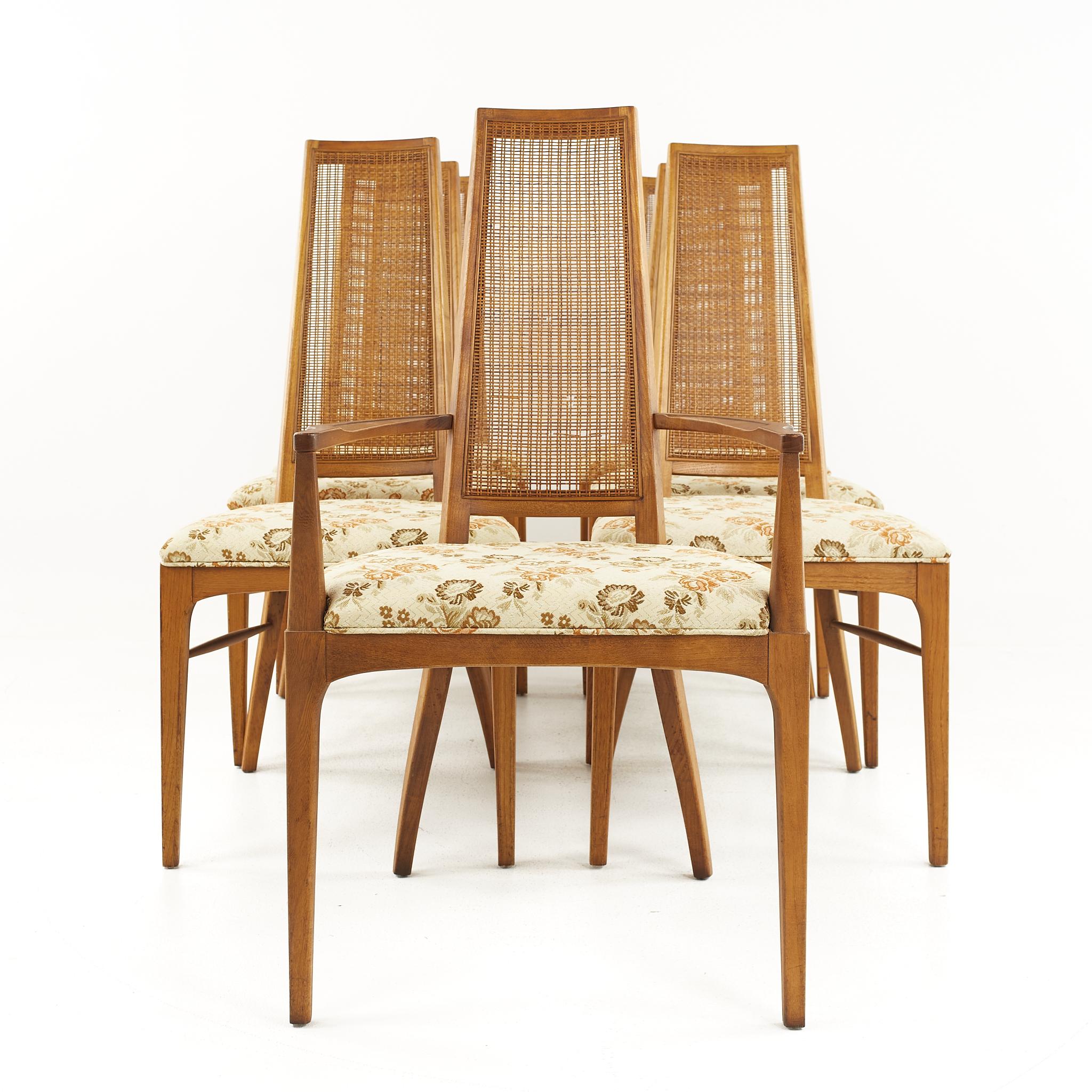 Lane rhythm mid-century walnut and cane dining chairs - set of 7

The side chairs measures: 19.25 wide x 19 deep x 41.25 high, with a seat height of 18.75 inches
The captains chair measures: 22.25 wide x 19 deep x 41.25 high, with a seat height