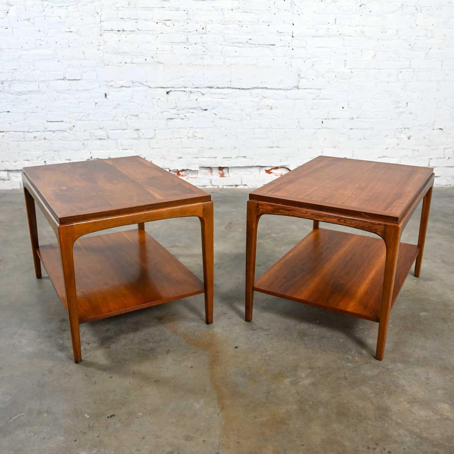 Lovely pair of Lane Rhythm Collection Mid-Century Modern walnut end tables with a lower shelf. Beautiful condition, keeping in mind that these are vintage and not new so will have signs of use and wear. The tops have been refinished and given a new