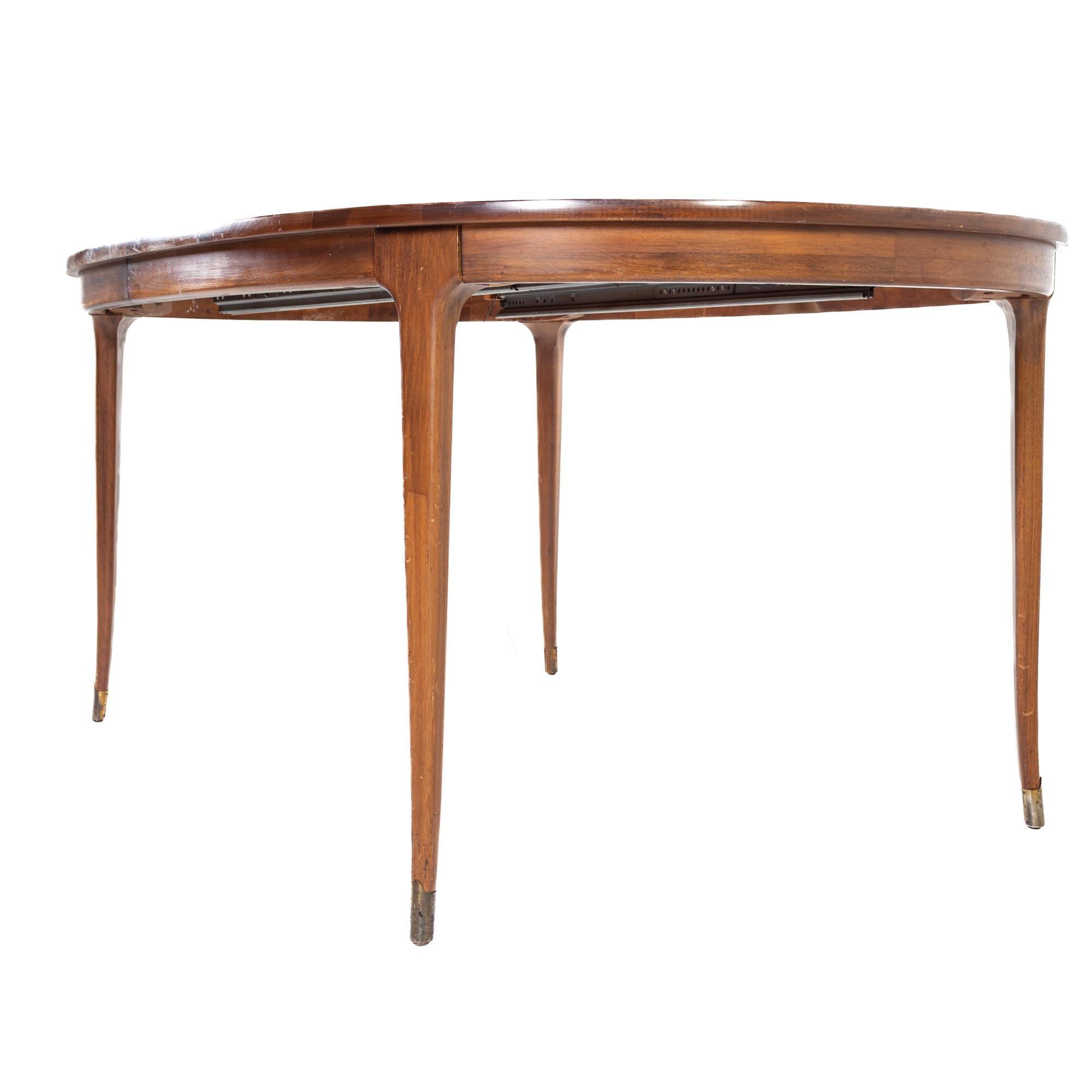 Late 20th Century Lane Rhythm Style Mid Century Oval Walnut Dining Table with Brass Tipped Legs an