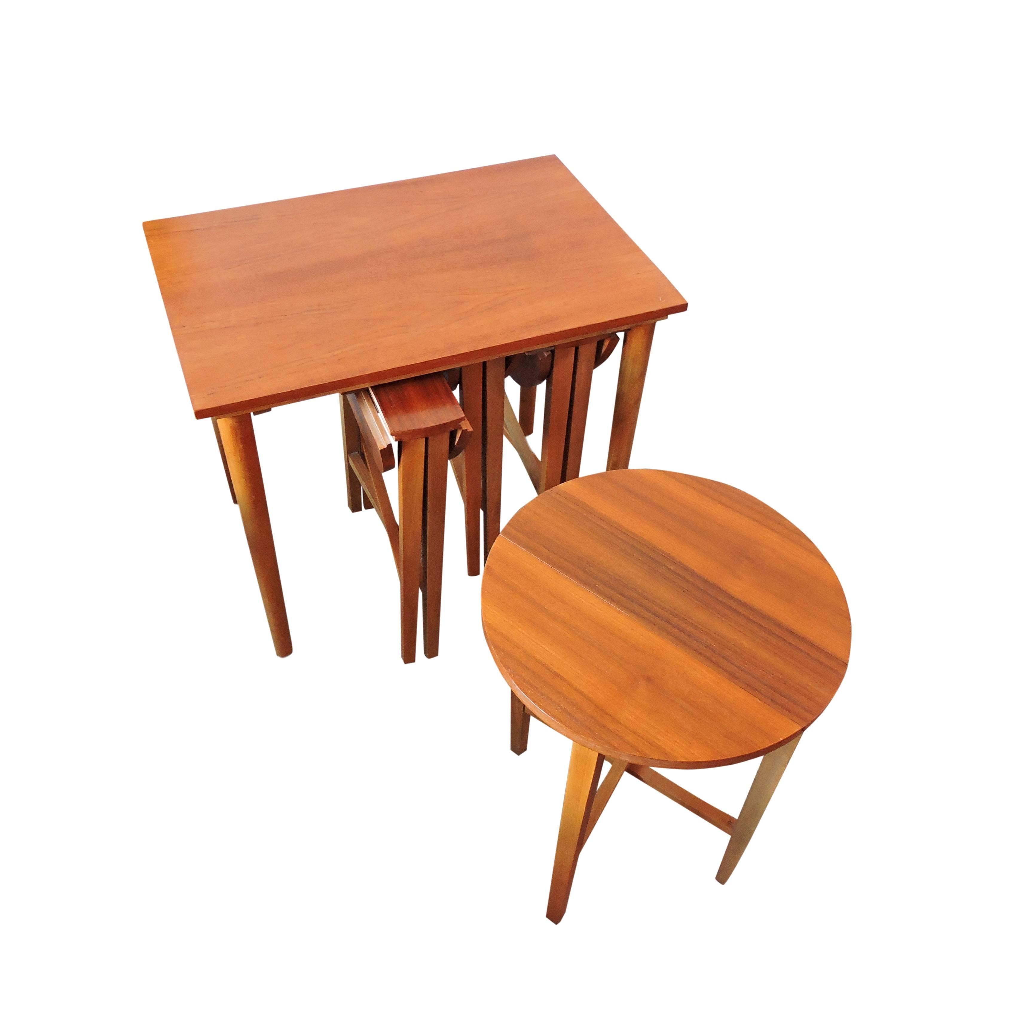 This set consists of a rectangular side table with four folding side tables that slide underneath.