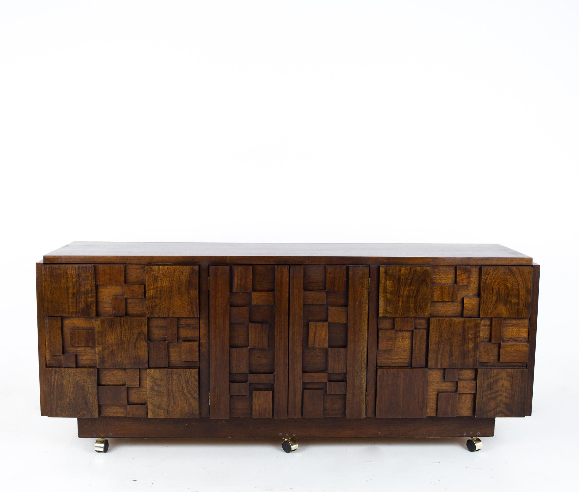 Lane Staccato Brutalist Mid Century 9 Drawer Walnut Lowboy Dresser

Dresser measures: 78 wide x 18.75 deep x 30 inches high

All pieces of furniture can be had in what we call restored vintage condition. That means the piece is restored upon