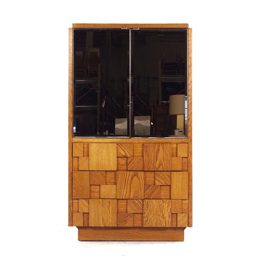 Lane Staccato Mid Century Oak Brutalist Mirrored Armoire

This armoire measures: 36 wide x 19 deep x 63.5 inches high

All pieces of furniture can be had in what we call restored vintage condition. That means the piece is restored upon purchase so