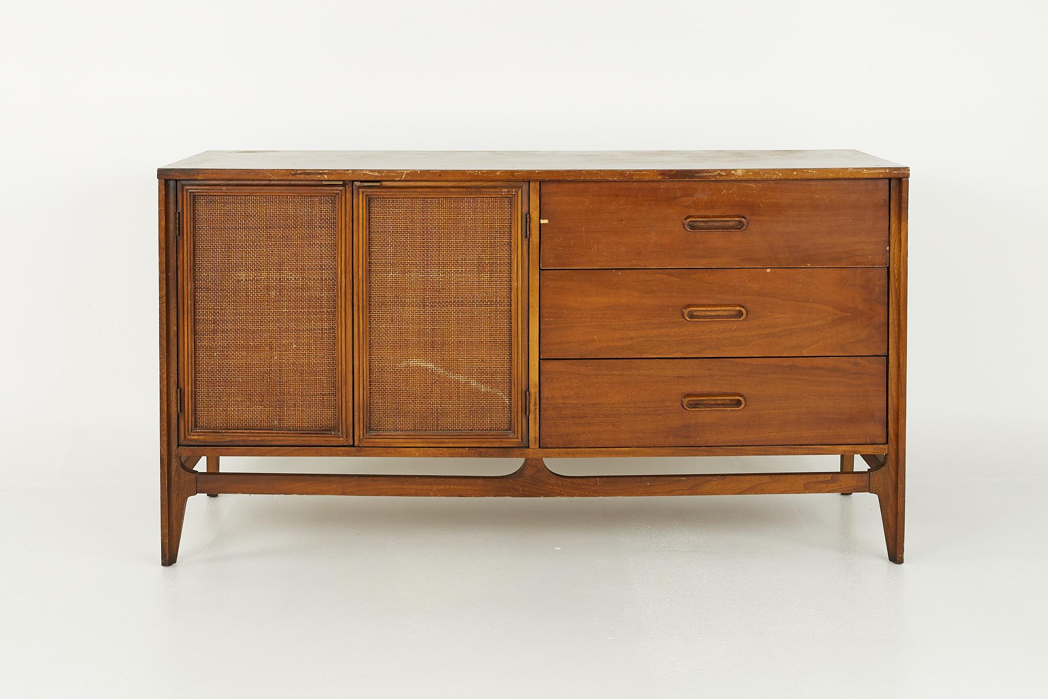 Lane style mid century walnut and cane front credenza

Credenza measures: 56 wide x 19 deep x 30 inches high

?All pieces of furniture can be had in what we call restored vintage condition. That means the piece is restored upon purchase so it’s