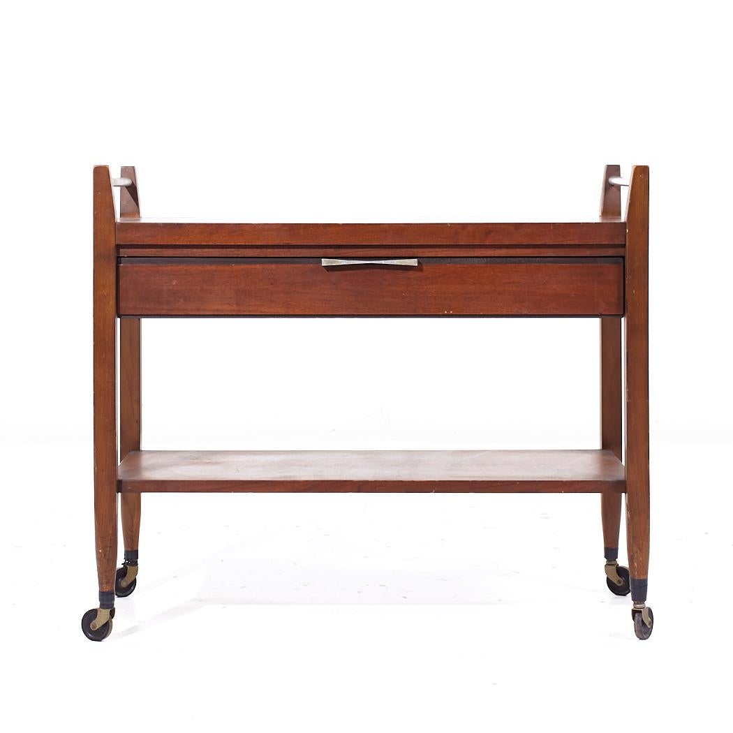 Lane Tuxedo Mid Century Walnut Serving Bar Cart

This bar cart measures: 34 wide x 16 deep x 29.25 inches high
When extended the width is 56 inches
The tabletop height is 25.75 inches

We take our photos in a controlled lighting studio to show as