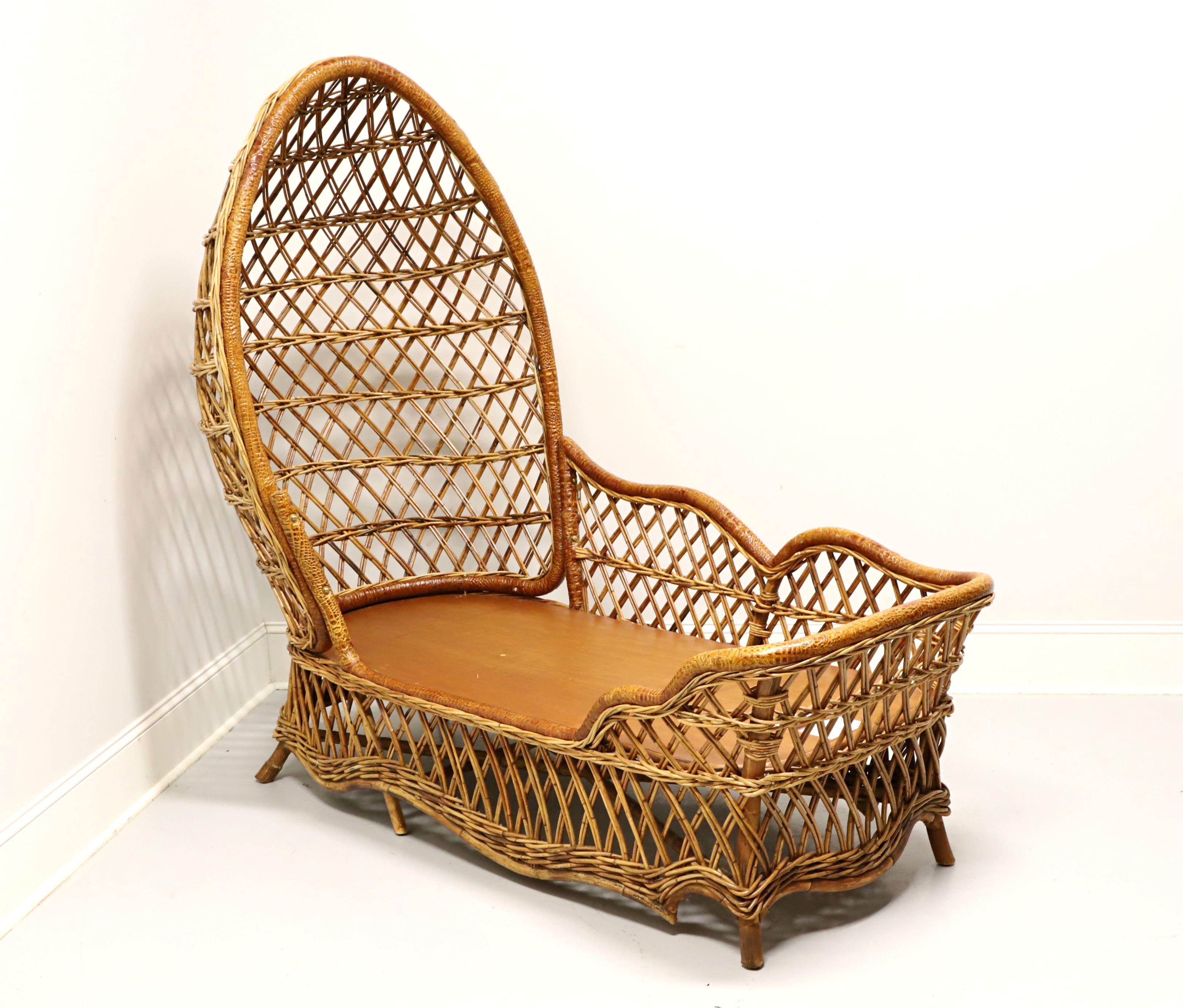 A Safari style rattan wicker chaise lounge by Lane Venture. Natural woven rattan wicker, wood frame, egg-like surround high back, decorative faux reptilian leather wrap to edges, solid wood under cushion support, and flared legs. Features the woven