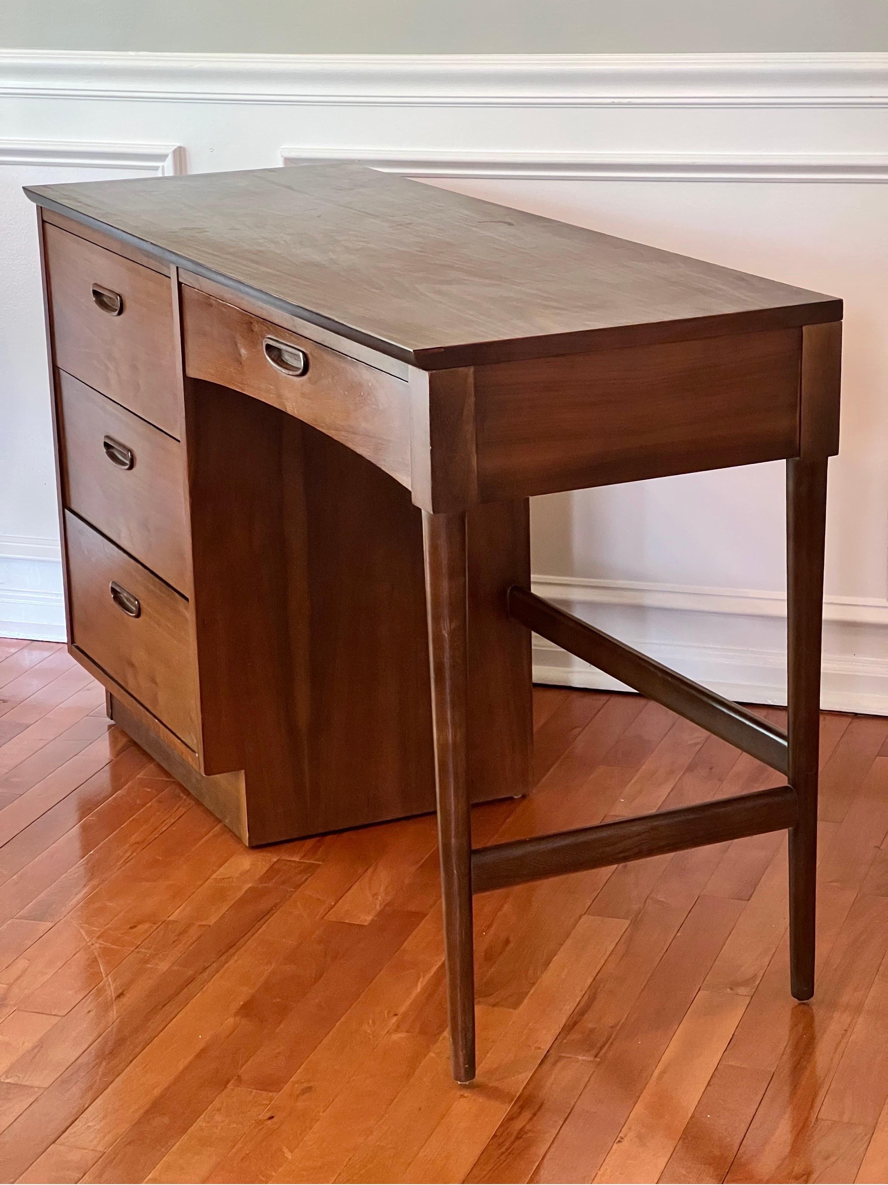 Beautiful vintage Lane Mid-Century Modern walnut desk. This piece features atomic tapered legs, laminate top and large dovetail drawers with ample storage. A classic and elegant addition to your modern home office.