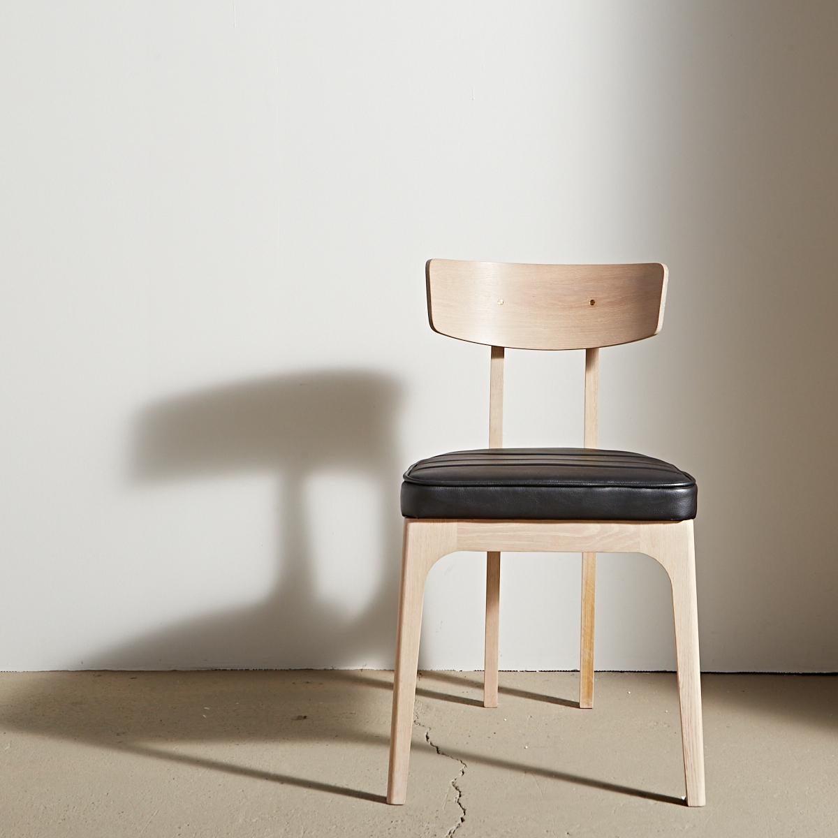 Unexpected angles provide an updated silhouette for a classic hardwood dining chair. Inspired by the European glamour of a Cafe Racer motorcycle, it has a strength and stability that defies the elegance of its slim legs. Featuring a bent solid