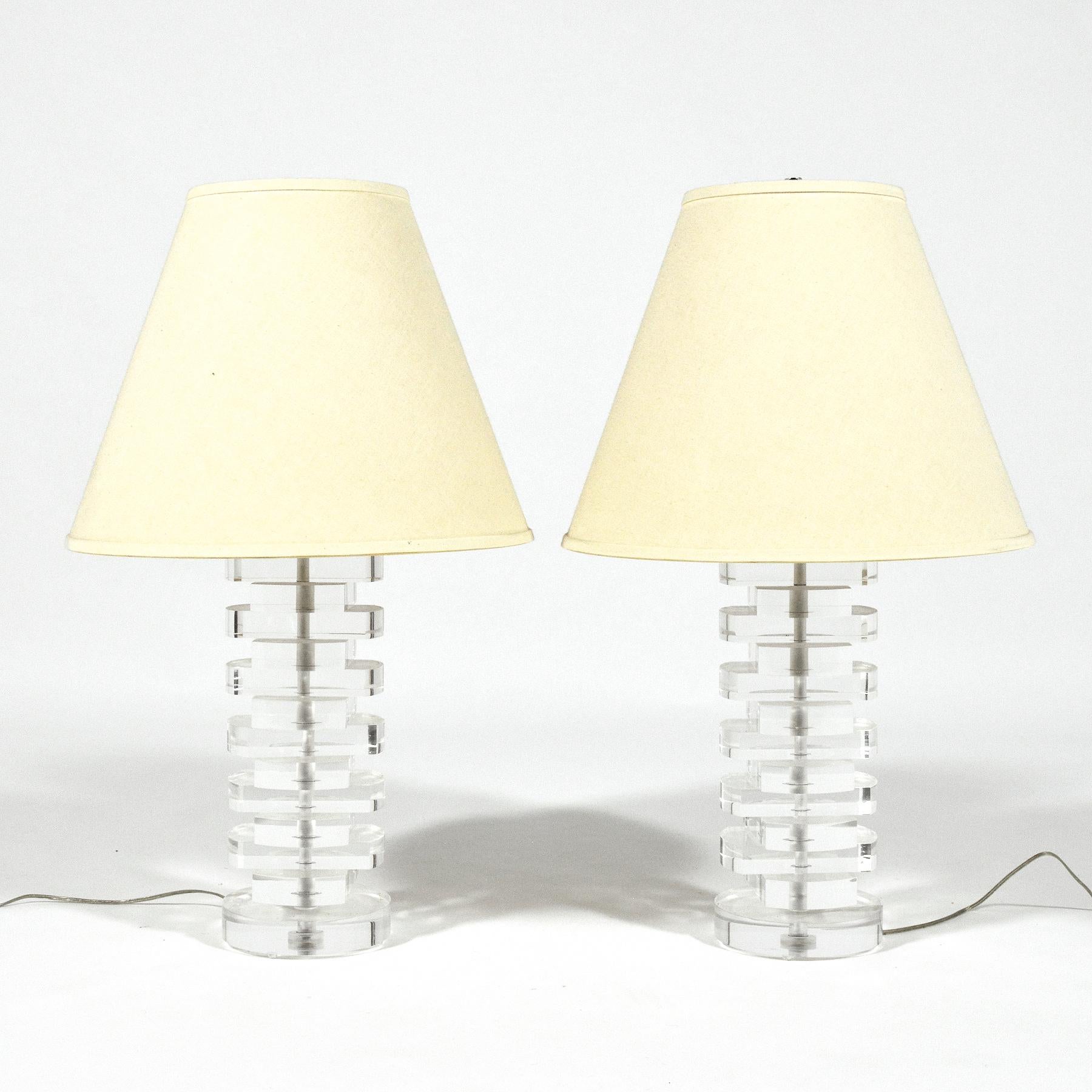 These elegant table lamps by Lang-Levin are far beyond the ordinary. A masterful combination of refined design and exceptional craftsmanship. Made of stacked Lucite shapes they change their appearance based on the viewer's perspective. No detail is