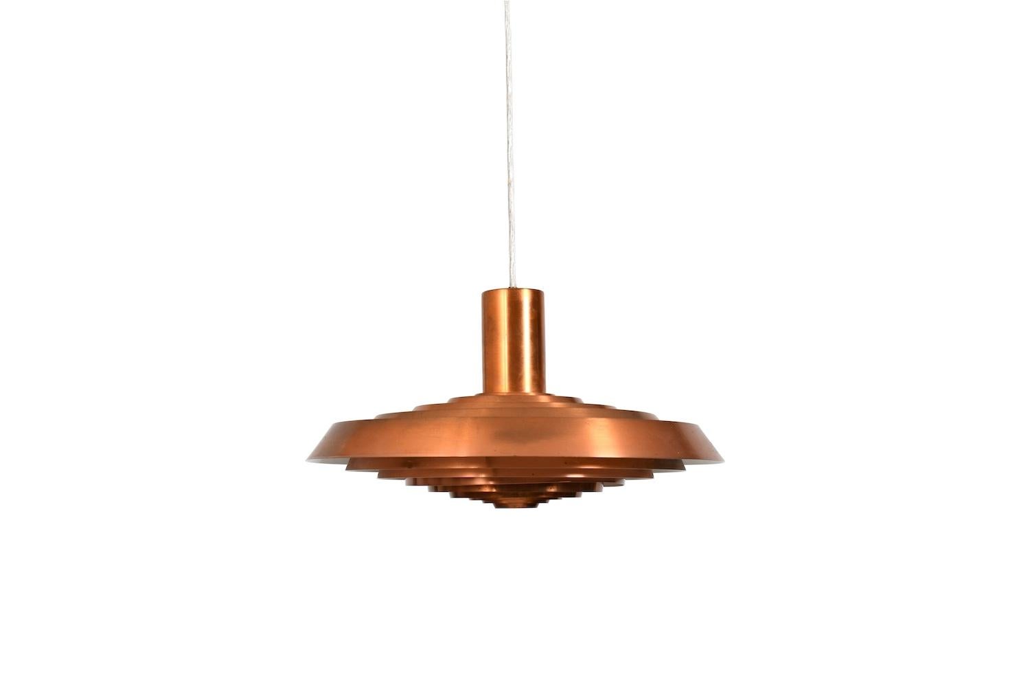 „Langelinie“ hanging lamp by Poul Henningsen for Louis Poulsen, Denmark, 1958. Poul Henningsen designed this lamp for the Langelinie restaurant in Copenhagen in 1958. Nine circular copper shades. Glare free light. The lamp creates a wonderful warm