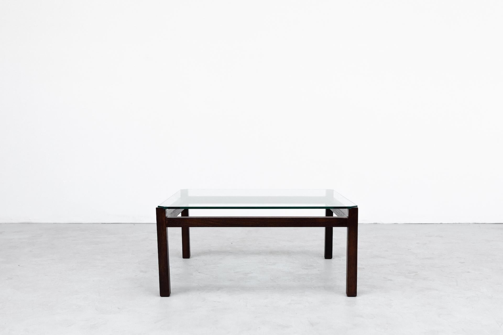 Mid-century 'Langerak' coffee table by Kho Liang Ie for 't Spectrum. Lightly refinished square wenge wood frame with floating glass top. In original condition with wear consistent with age and use.