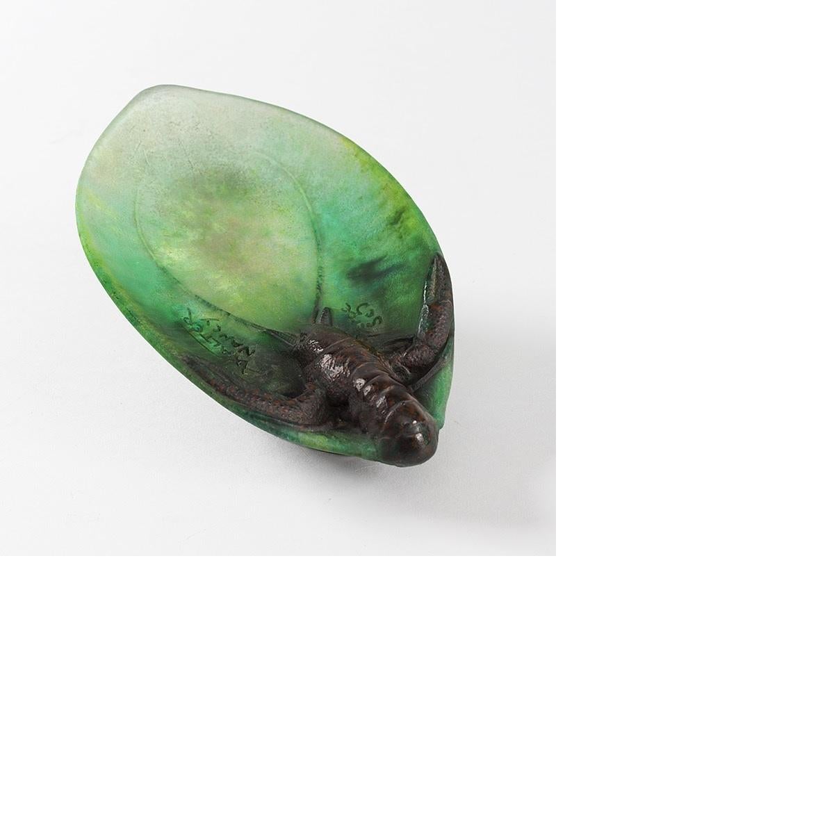 A French Art Nouveau pâte de verre vide-poche by Amalric Walter and Henri Bergé. This piece features a brown lobster resting on a blue-green shaped dish, circa 1900.

A similar vide-poche is pictured in: Amalric Walter (1870-1959), by Keith
