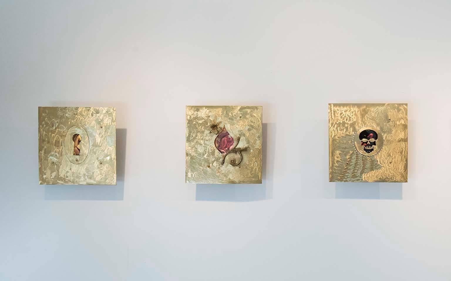 View Box 2, brass wall sculpture with sparkling rhinestones, reveals an erotic flower in petal pinks. The artist’s sculptural works and paintings investigate the  objectification of women historically and in contemporary society. Exploring female